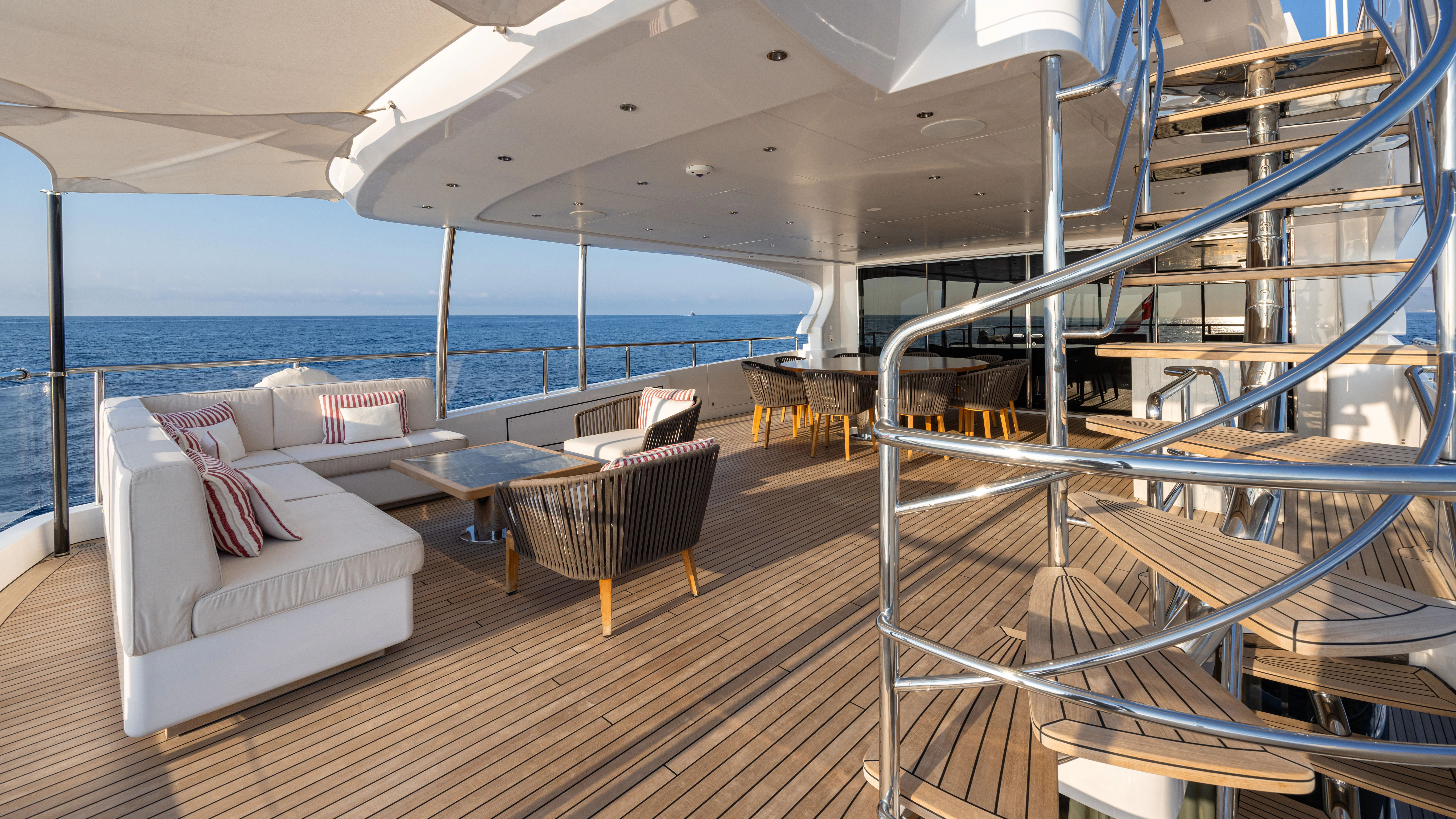 a room with a couch and a table and chairs aboard TRAMONTO Yacht for Charter