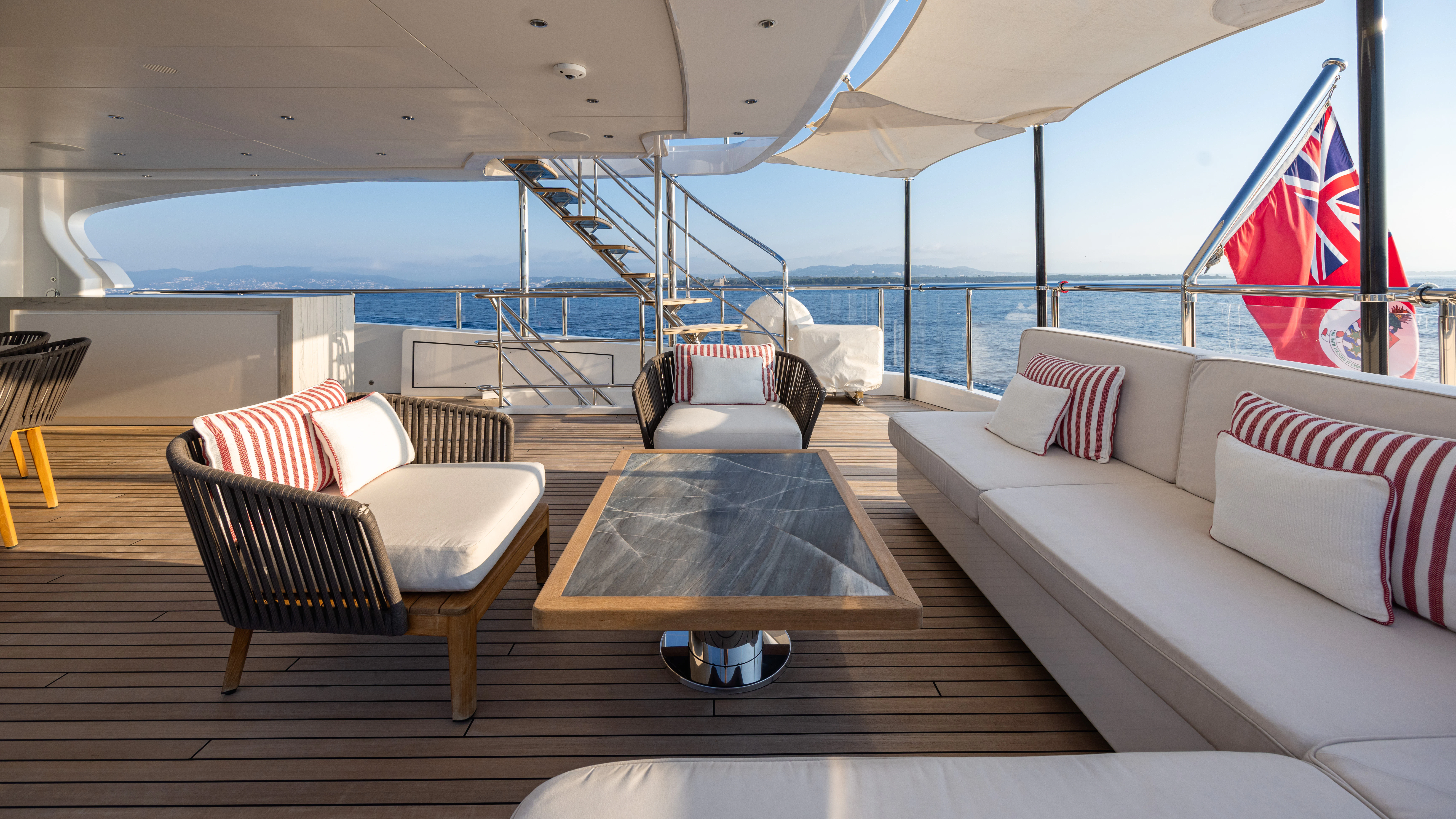 a room with a couch and a table and a table aboard TRAMONTO Yacht for Charter