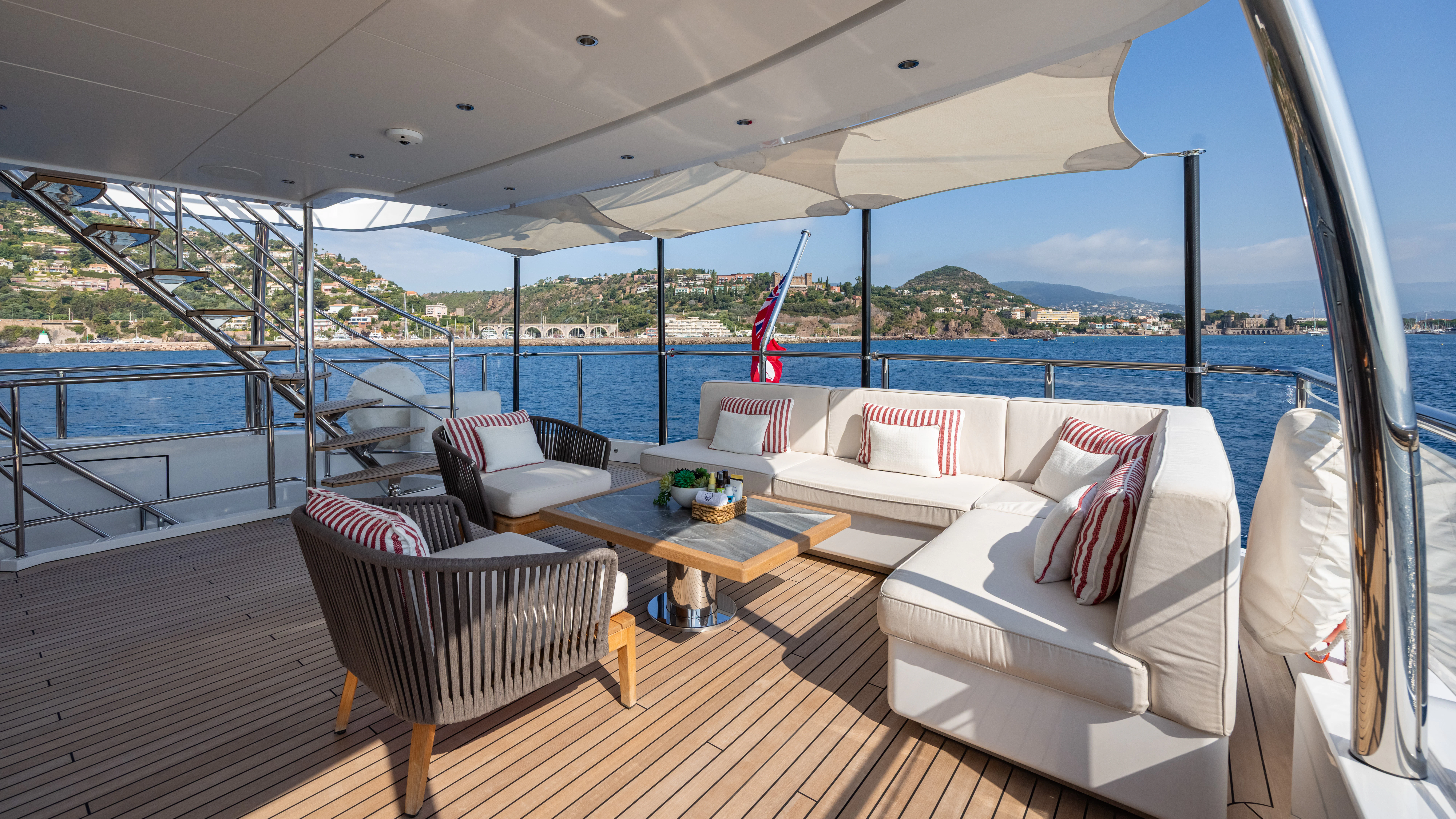 a room with a large bed and a table with chairs aboard TRAMONTO Yacht for Charter