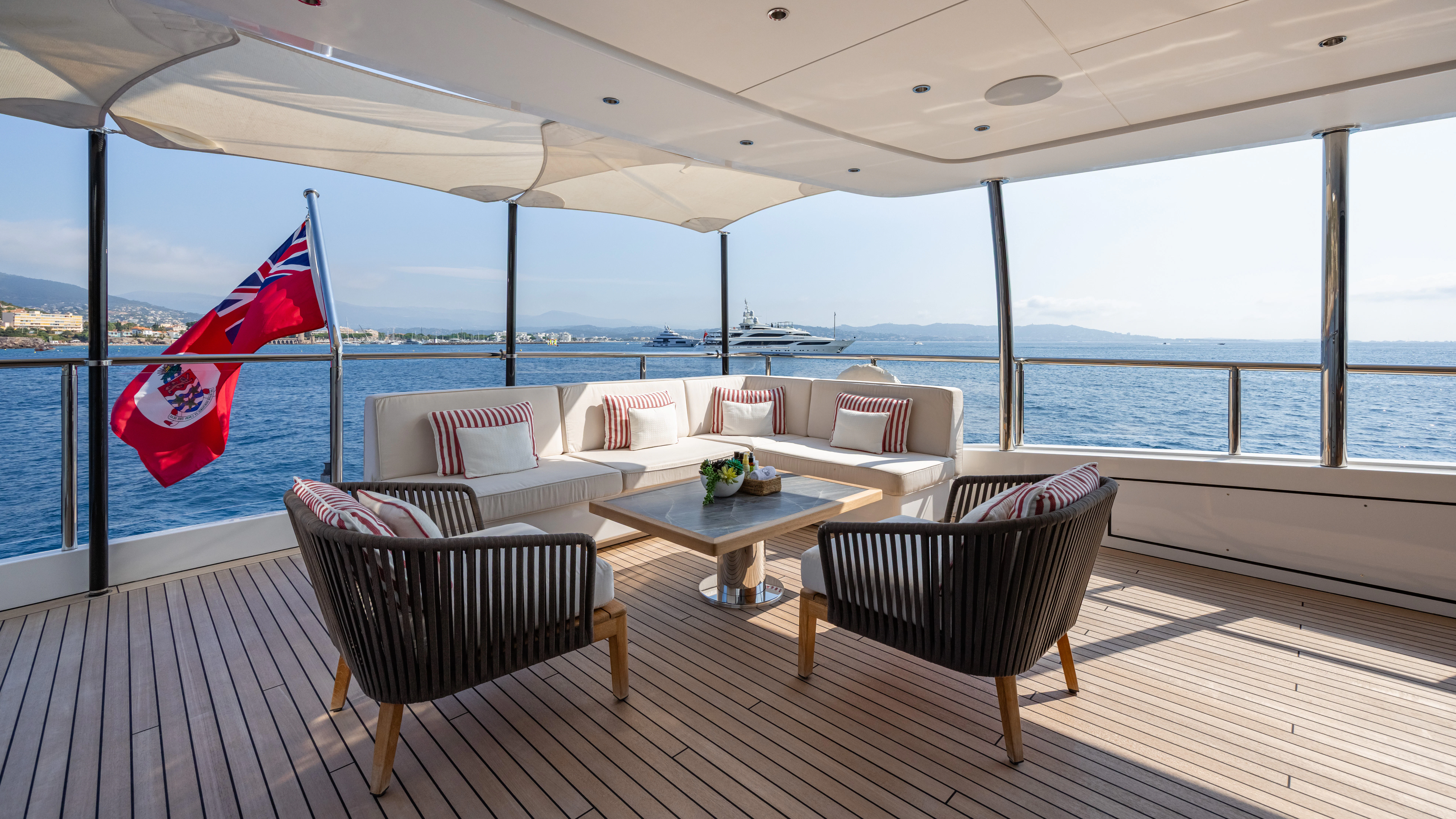 a living room with a large window overlooking the ocean aboard TRAMONTO Yacht for Charter