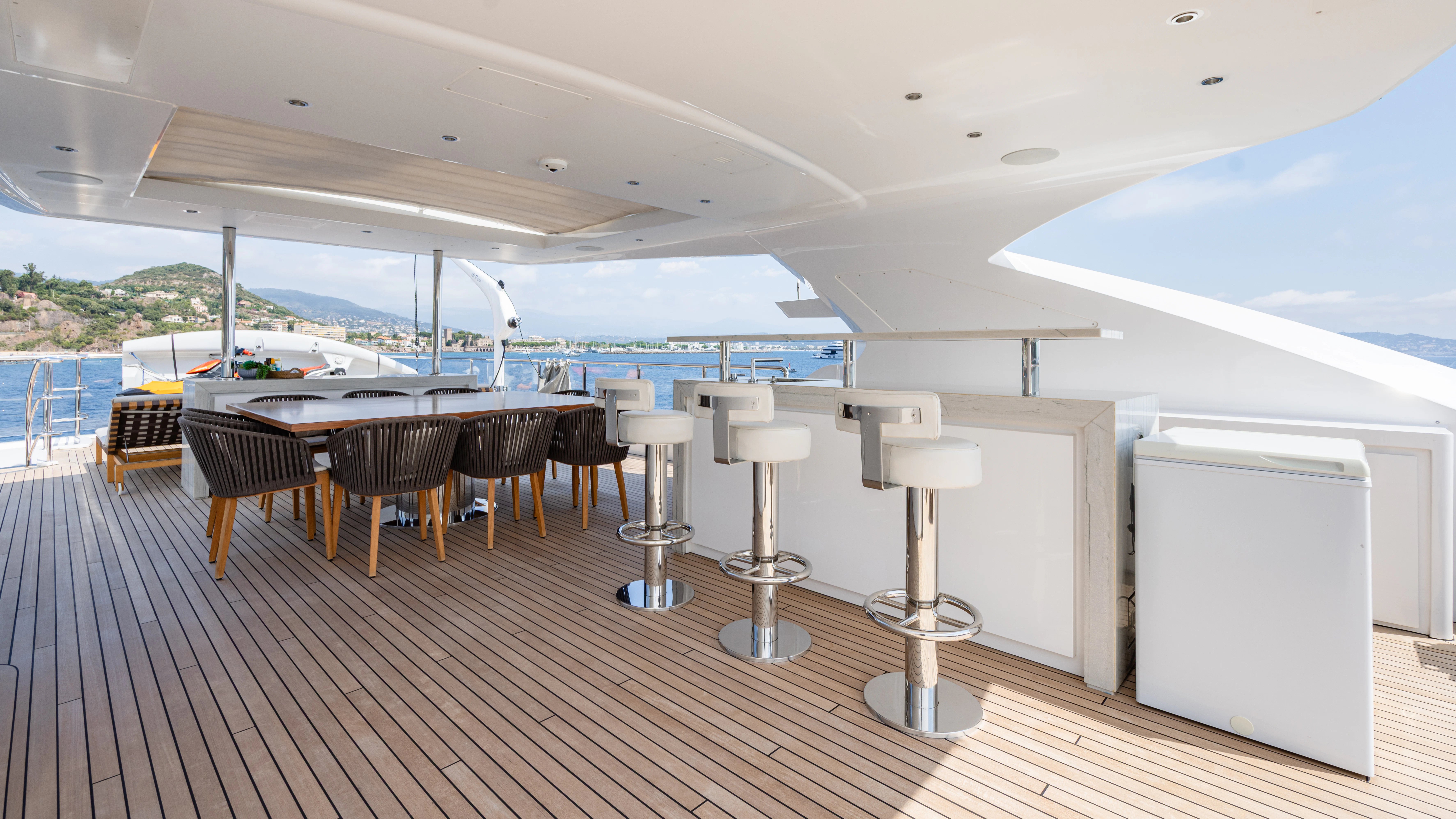 a room with tables and chairs aboard TRAMONTO Yacht for Charter