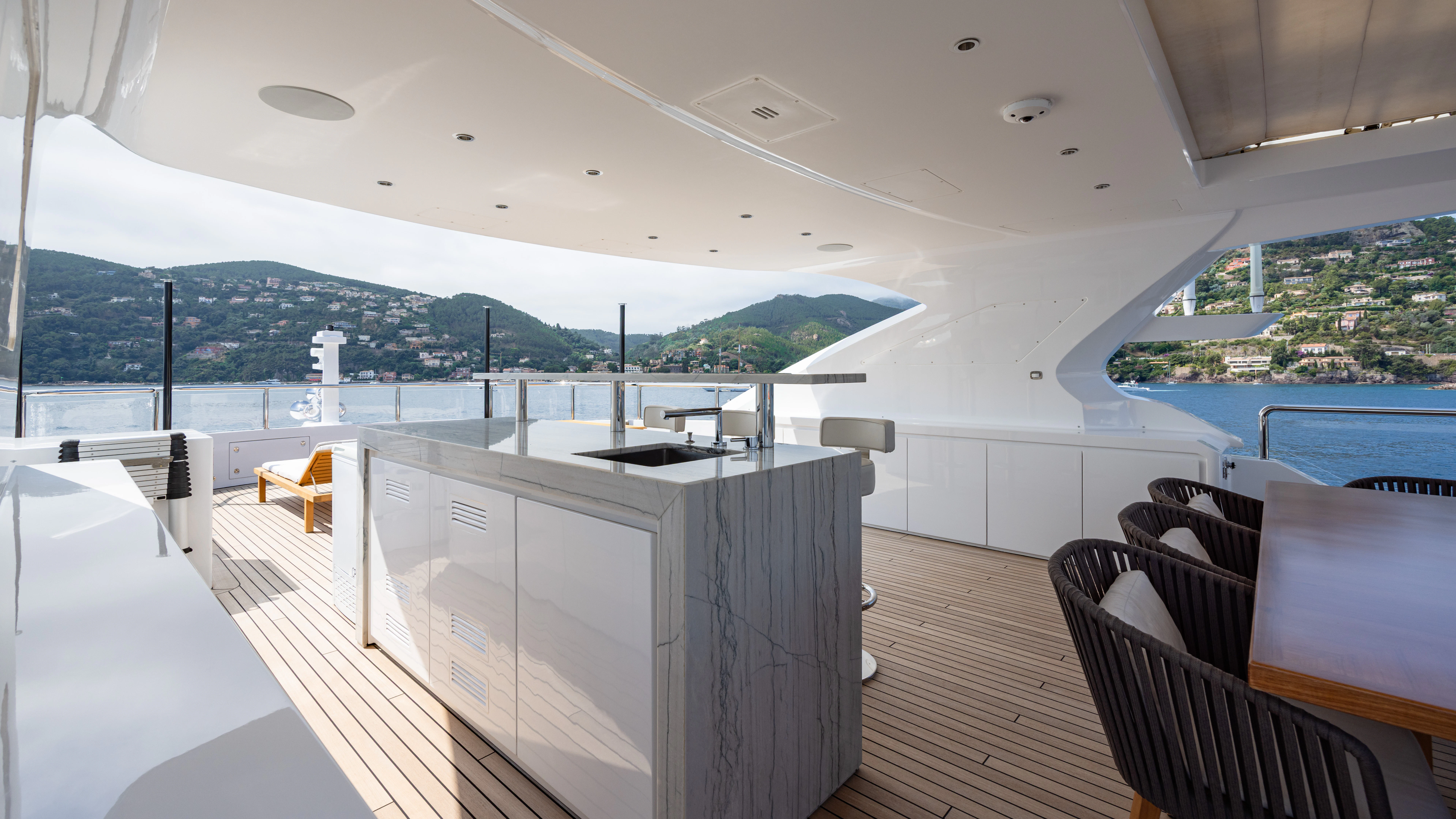 a room with a large white table and chairs and a large white building with a large white tower aboard TRAMONTO Yacht for Charter
