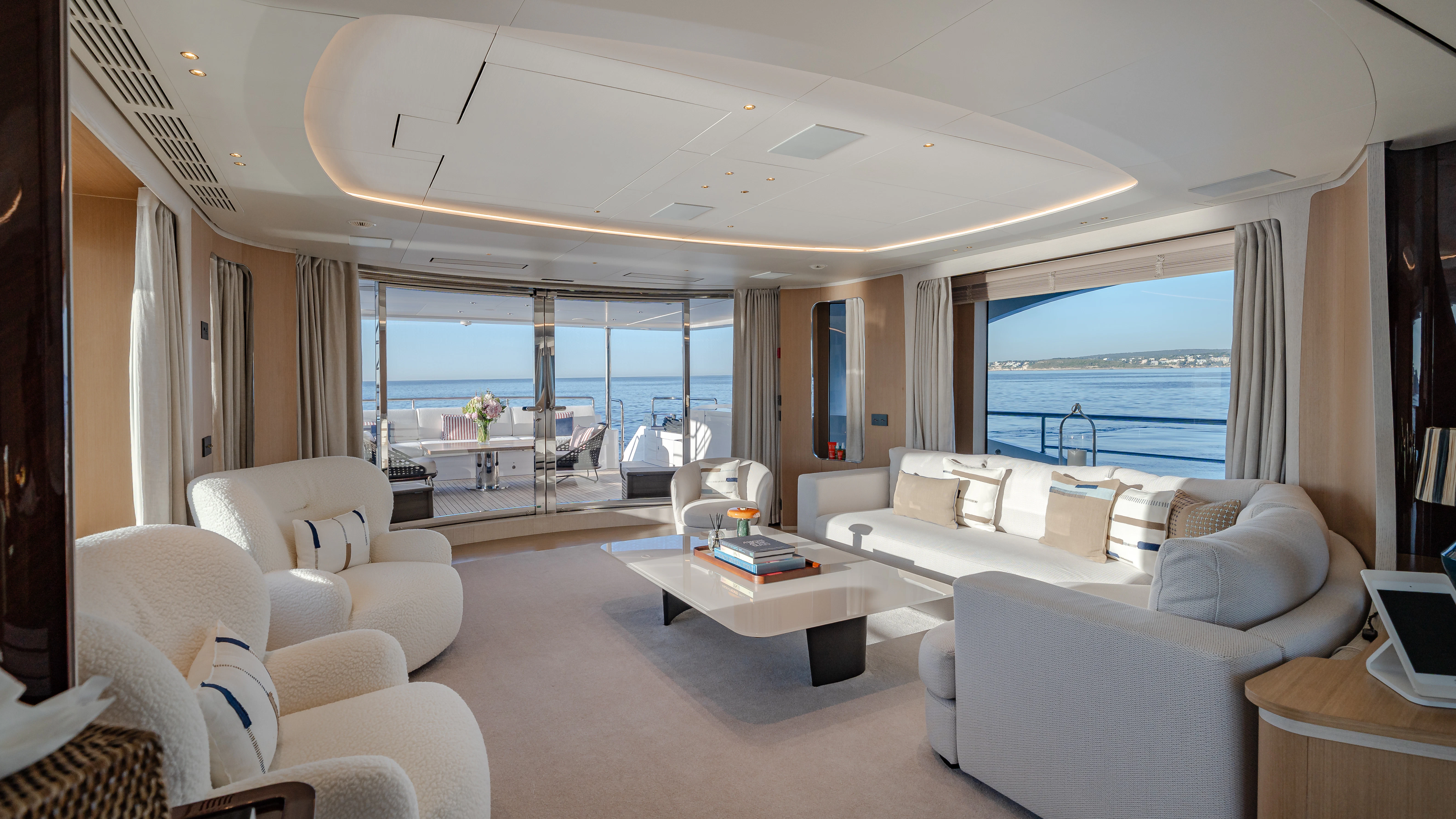 a living room with a large window aboard TRAMONTO Yacht for Charter