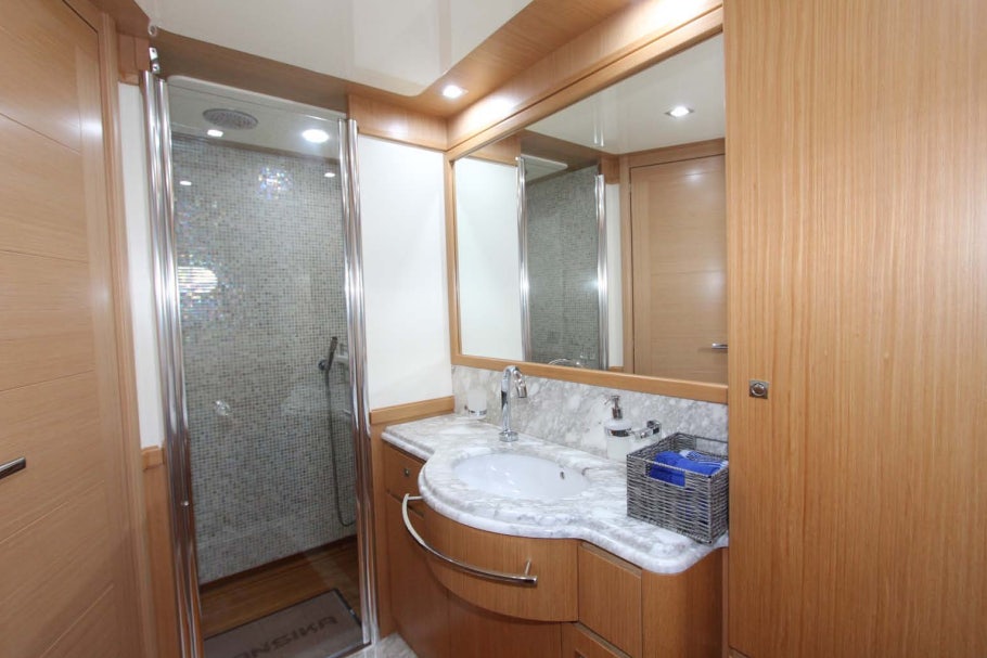 a bathroom with a glass shower door aboard ALL WE NEED FOR TODAY Yacht for Sale