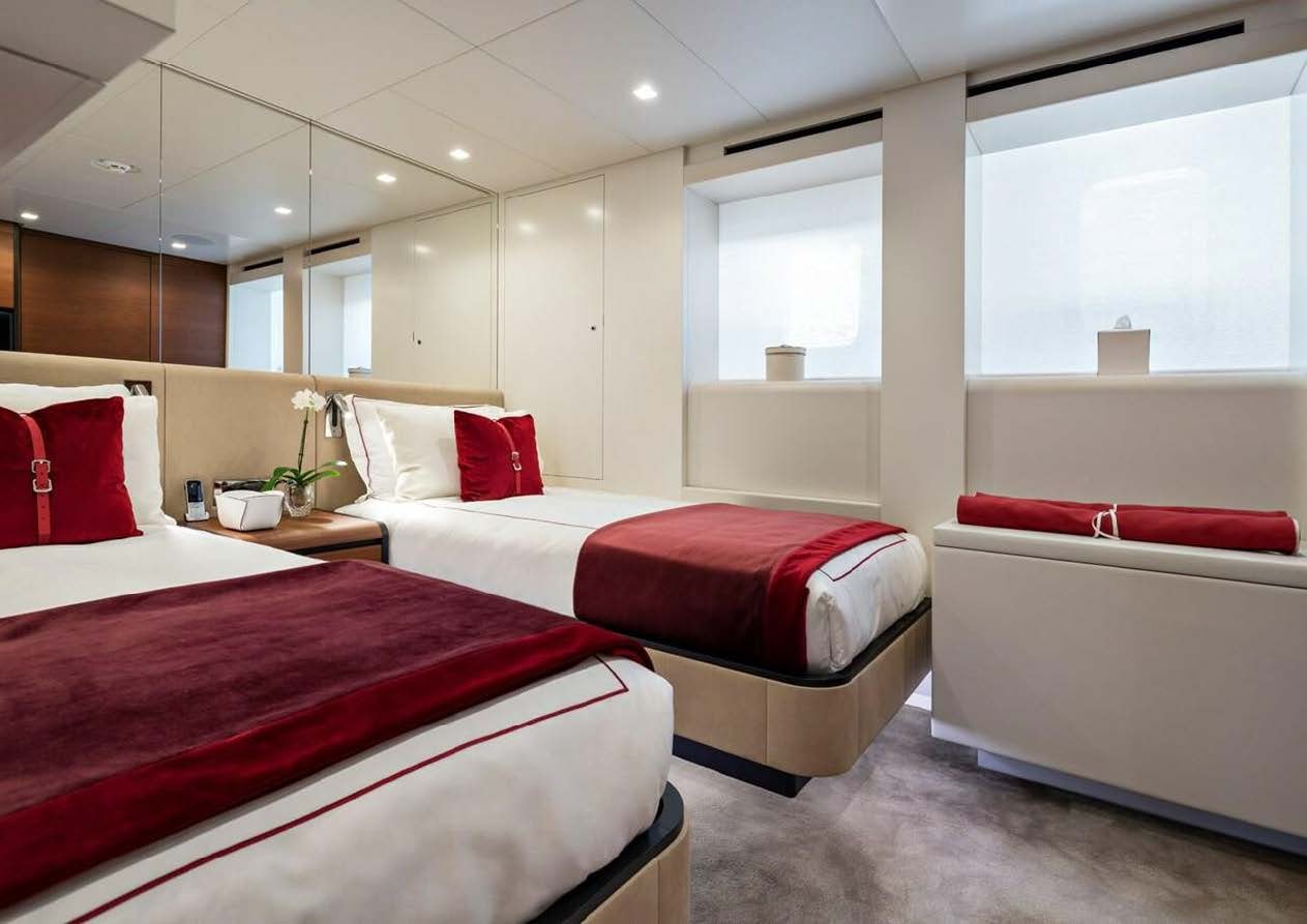a room with three beds aboard ELA Yacht for Sale