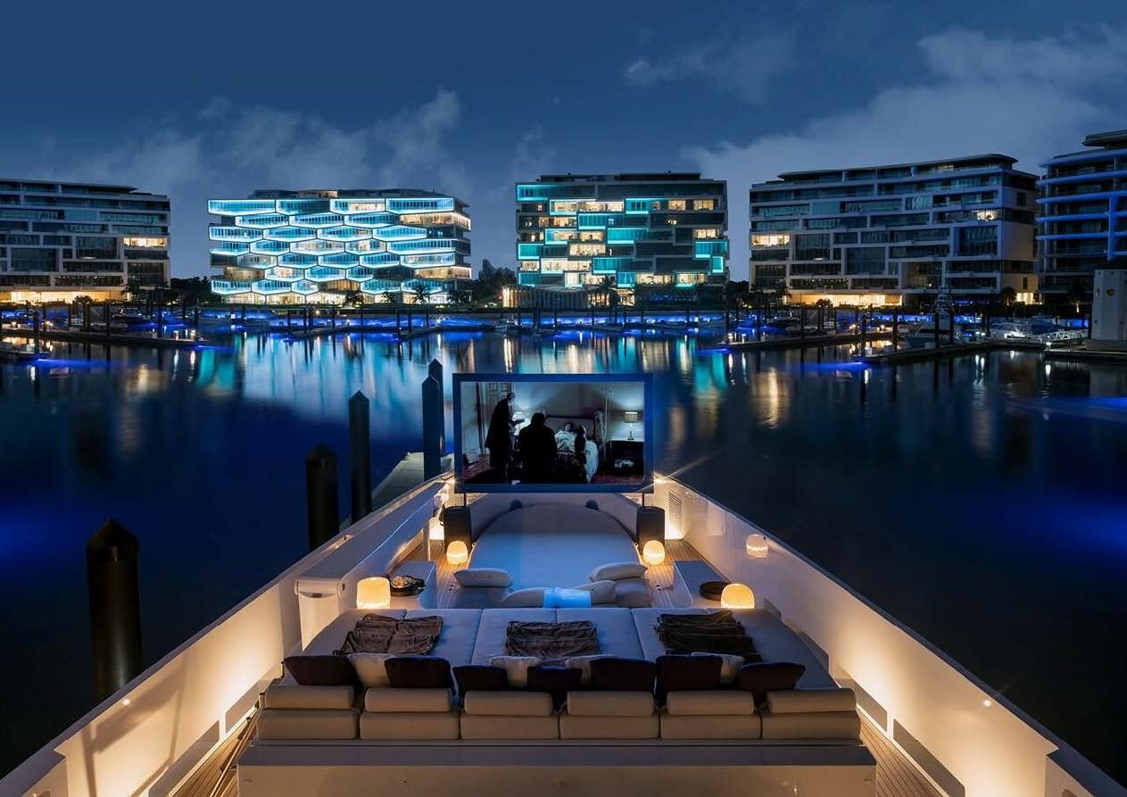 a deck with a view of a city and water aboard ELA Yacht for Sale