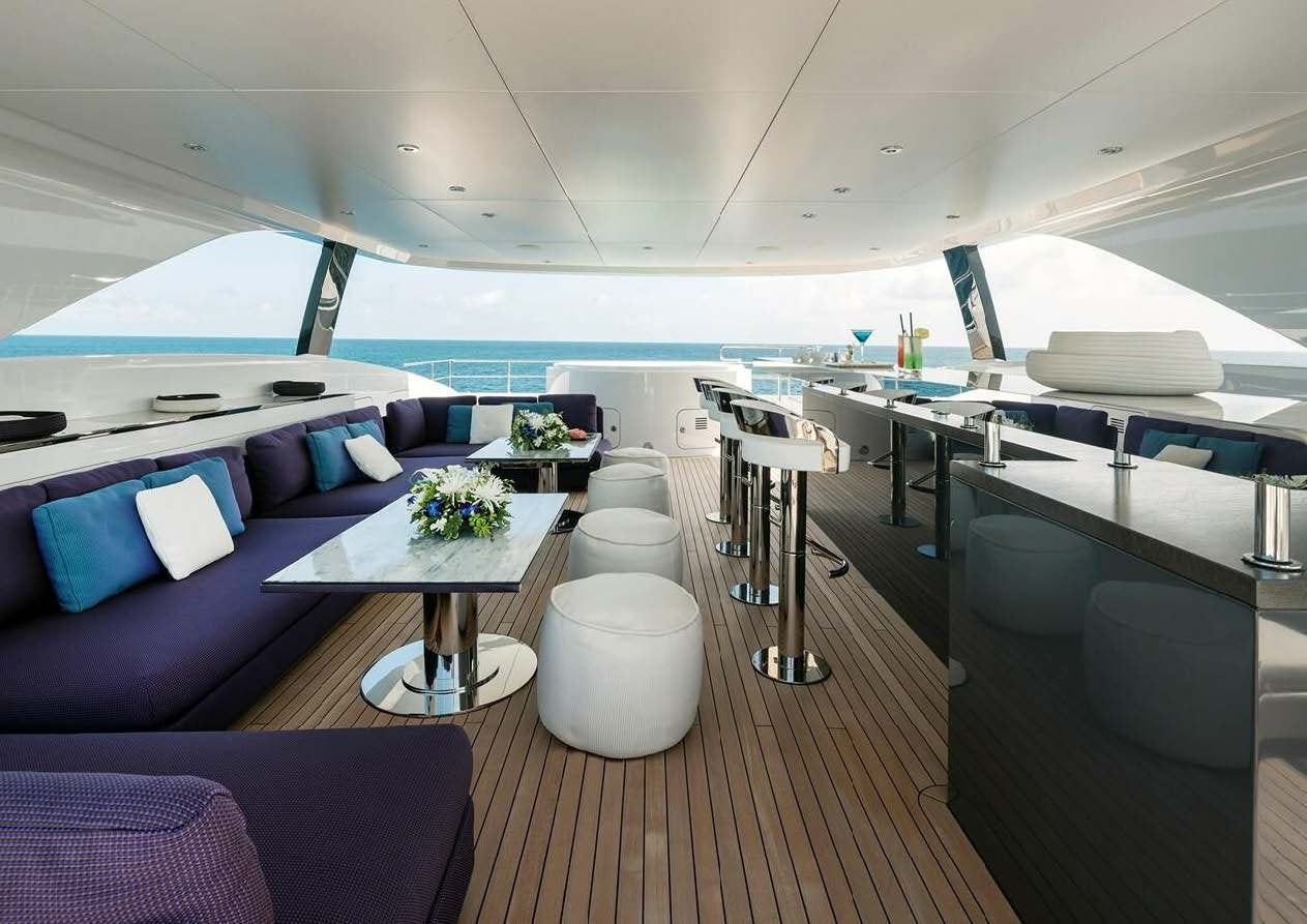 a room with a table and chairs aboard ELA Yacht for Sale