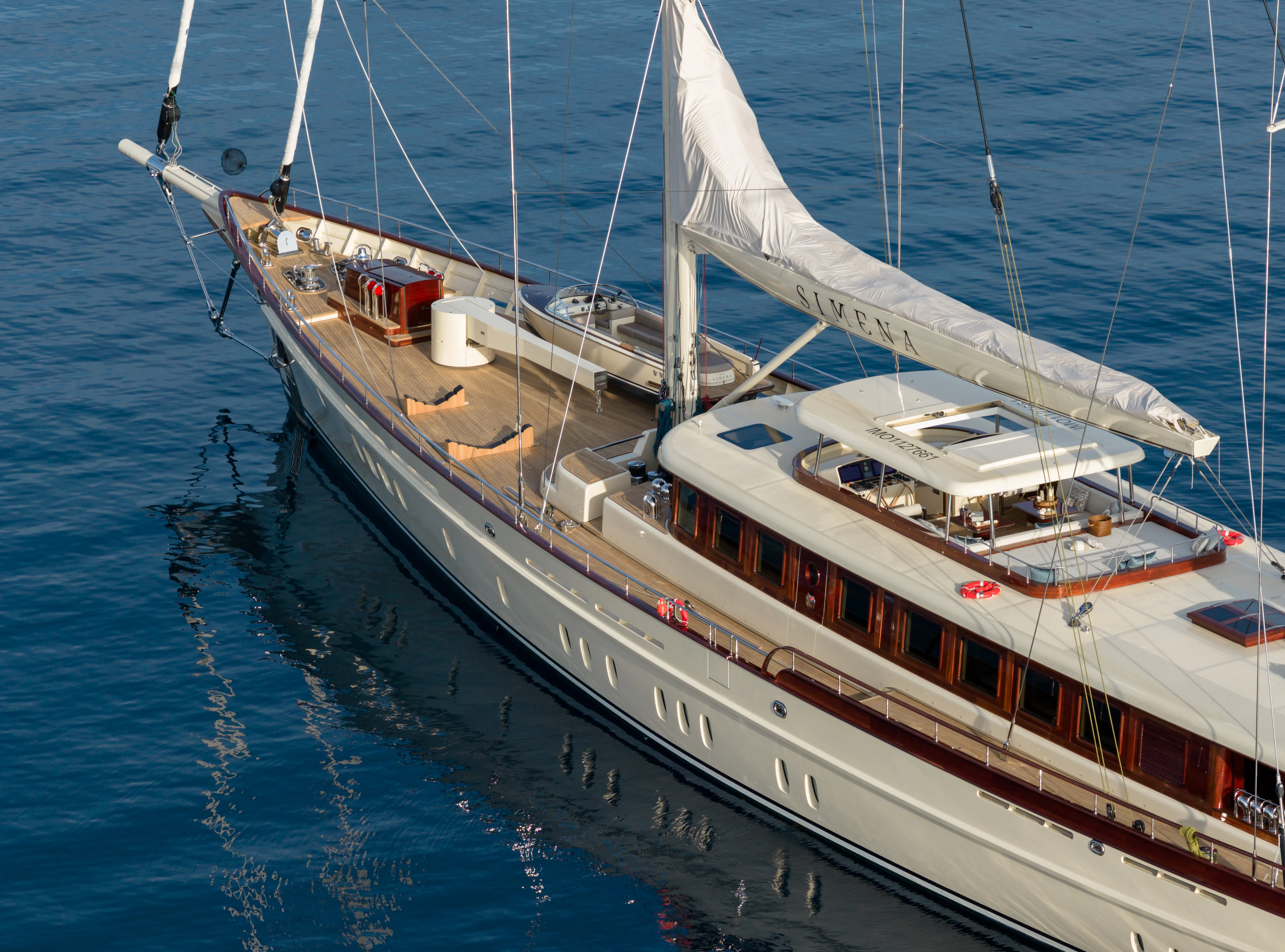 a large white boat with a white sail aboard SIMENA Yacht for Sale