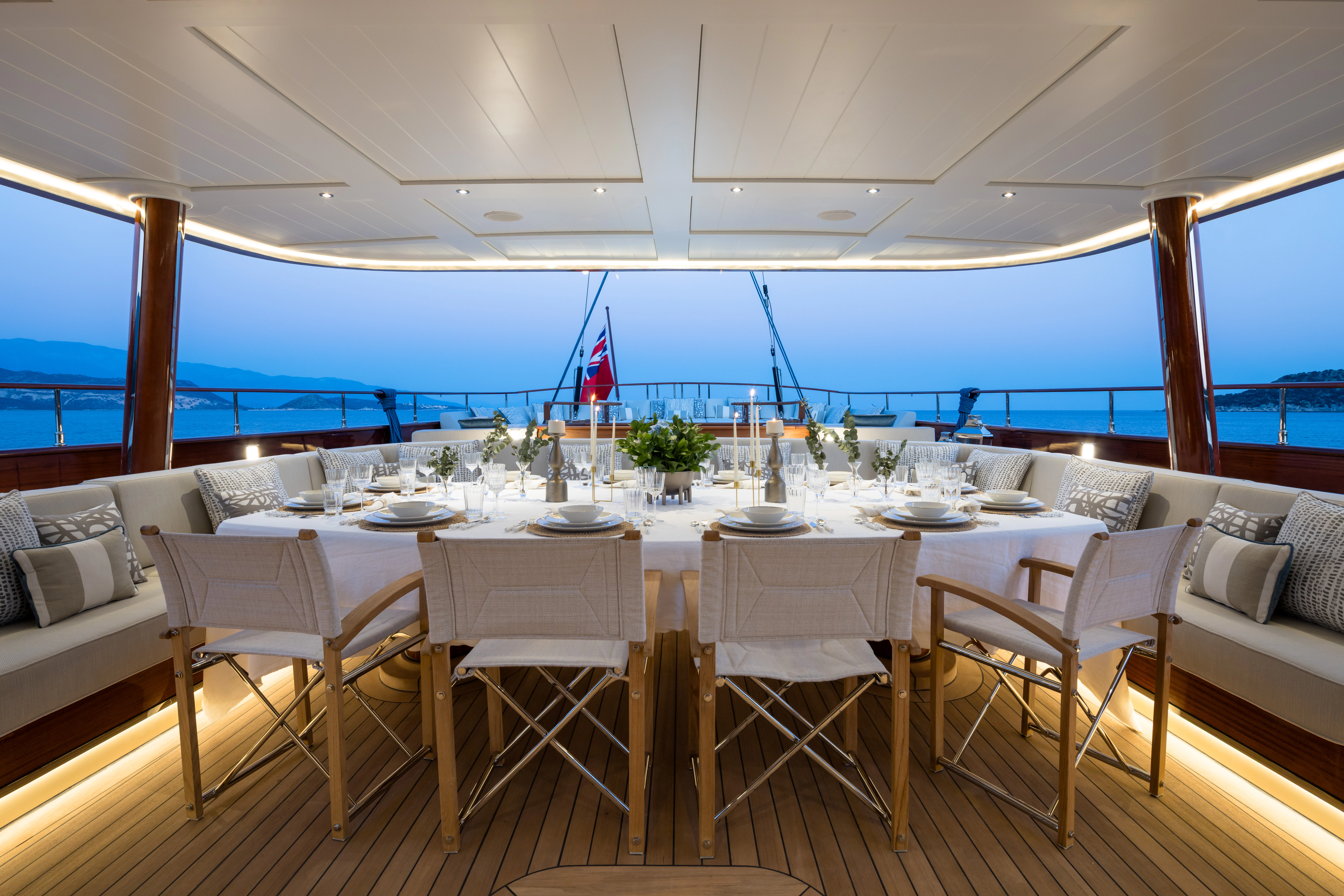 a large dining table with white chairs aboard SIMENA Yacht for Sale