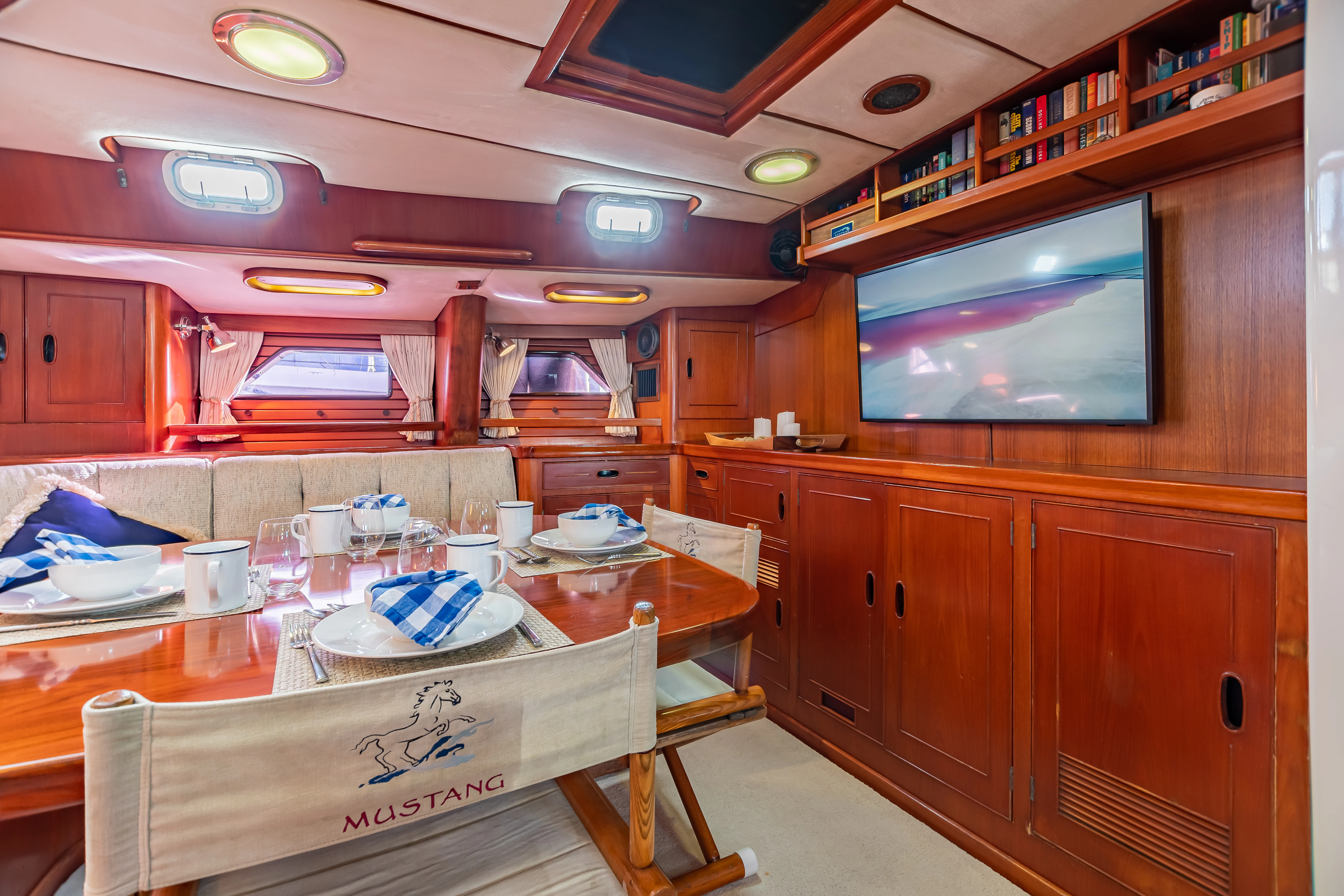 a kitchen with a table and chairs aboard MUSTANG Yacht for Sale