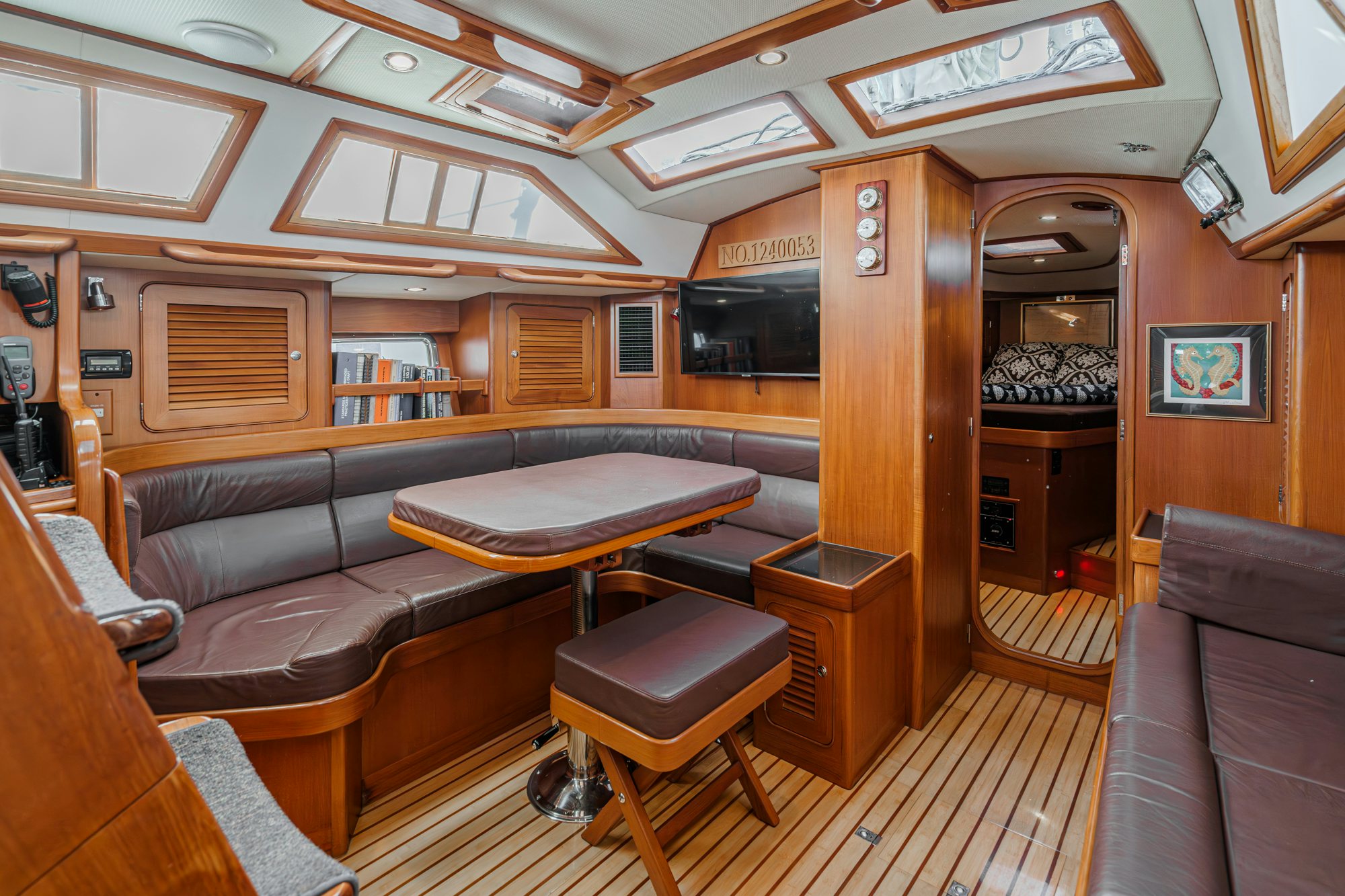 a room with a table and couch aboard FEATHER Yacht for Sale