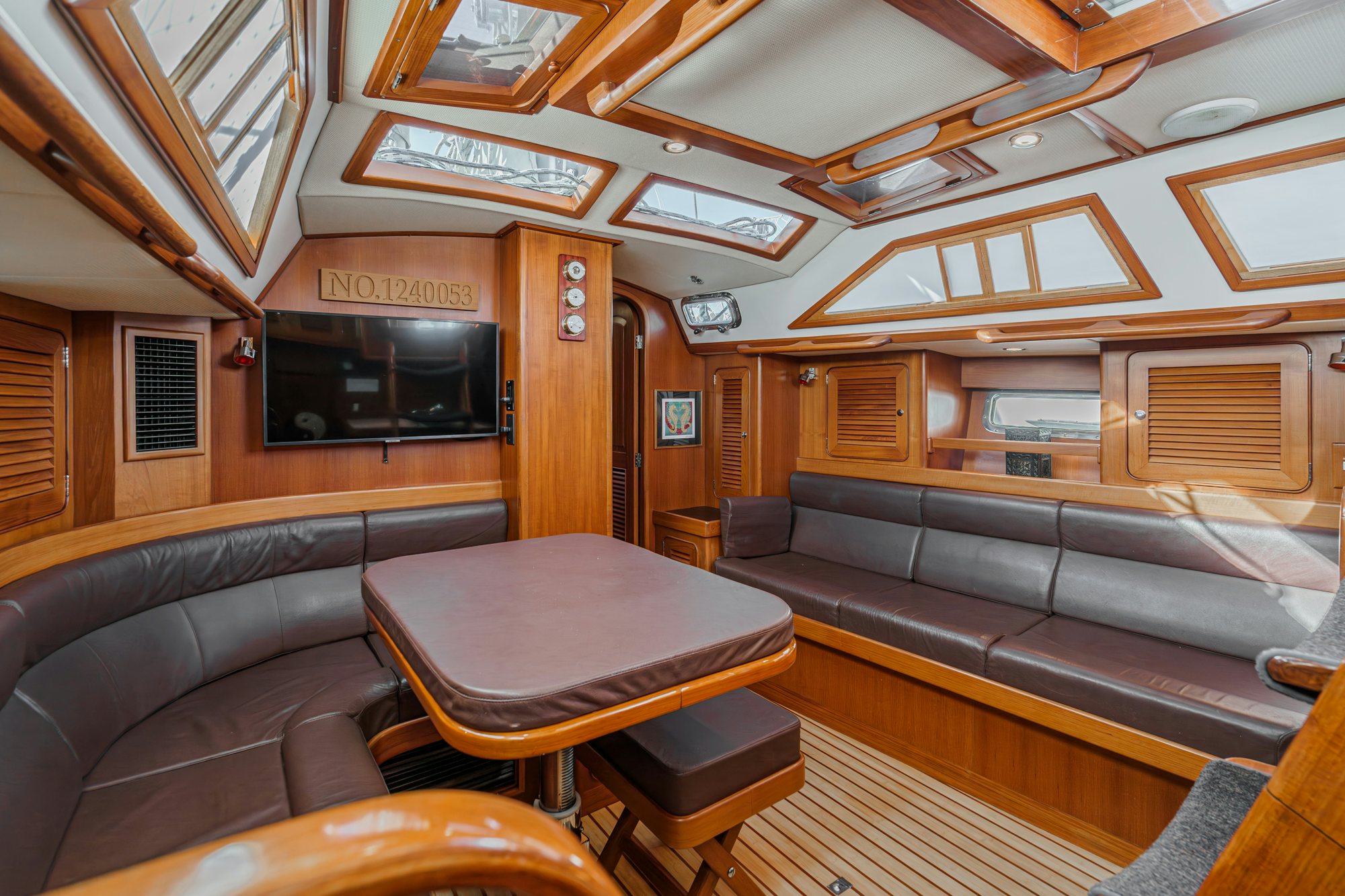 a living room with leather couches aboard FEATHER Yacht for Sale
