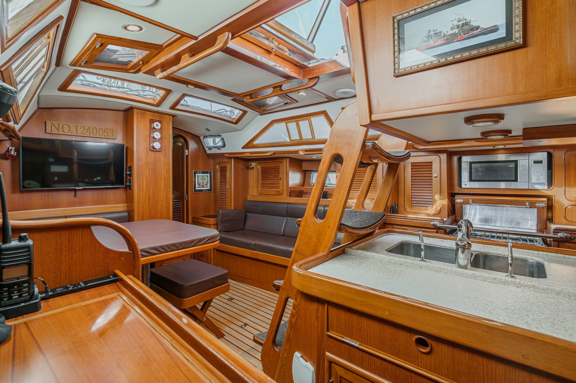 a kitchen with a wood stove and a table aboard FEATHER Yacht for Sale