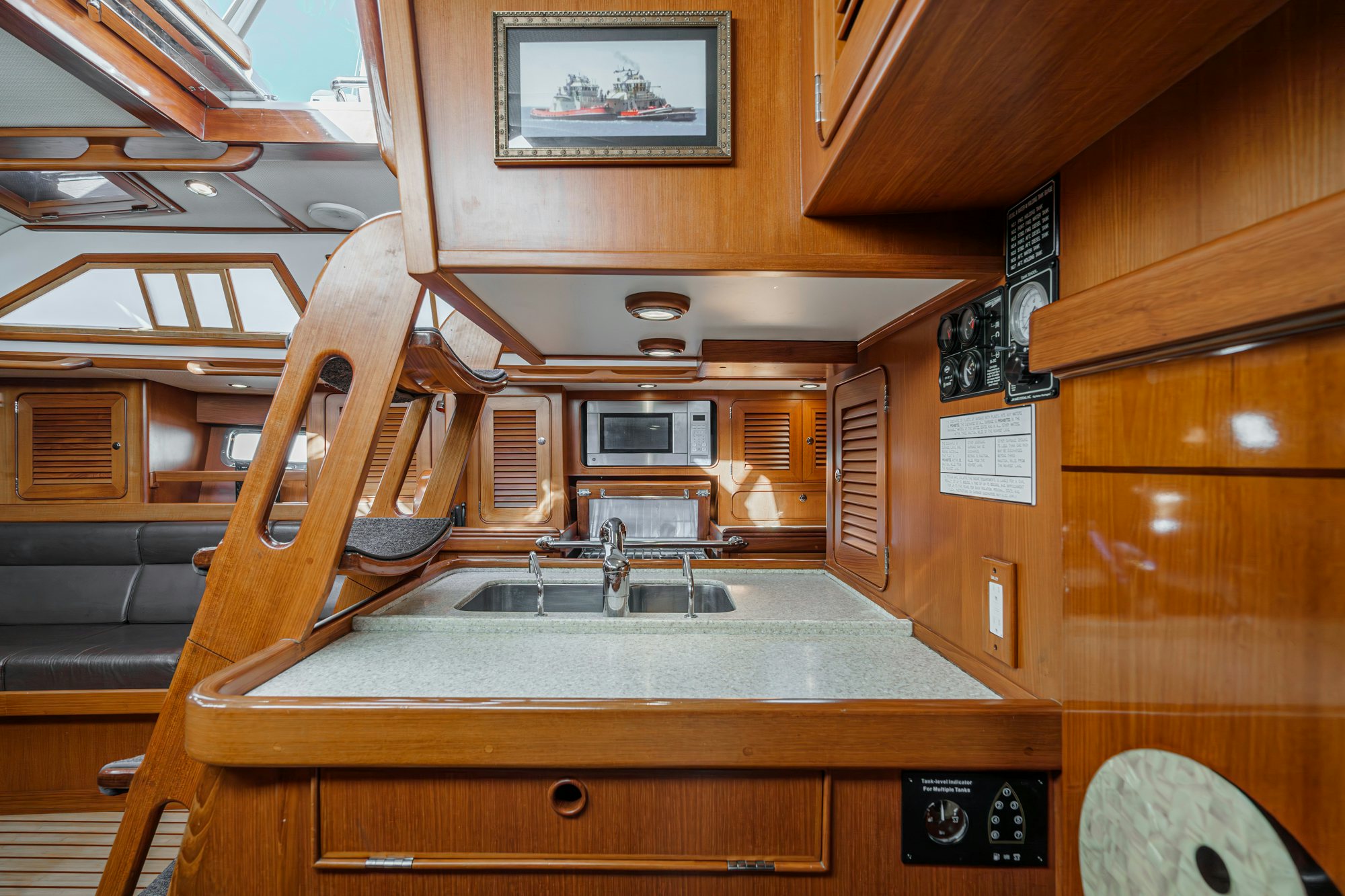 a kitchen with wooden cabinets aboard FEATHER Yacht for Sale