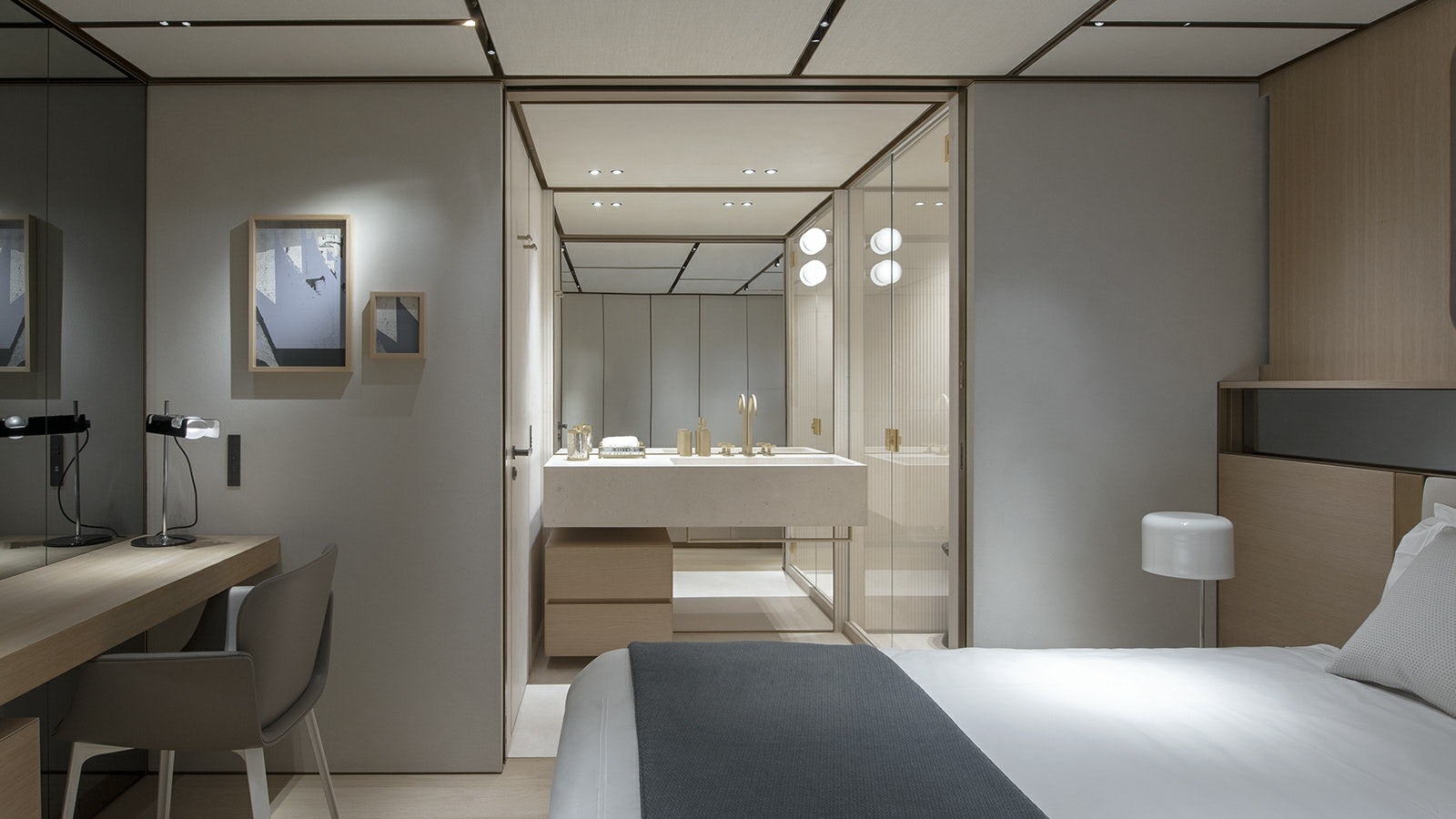 a room with a bed and desk aboard LA LA LAND Yacht for Charter