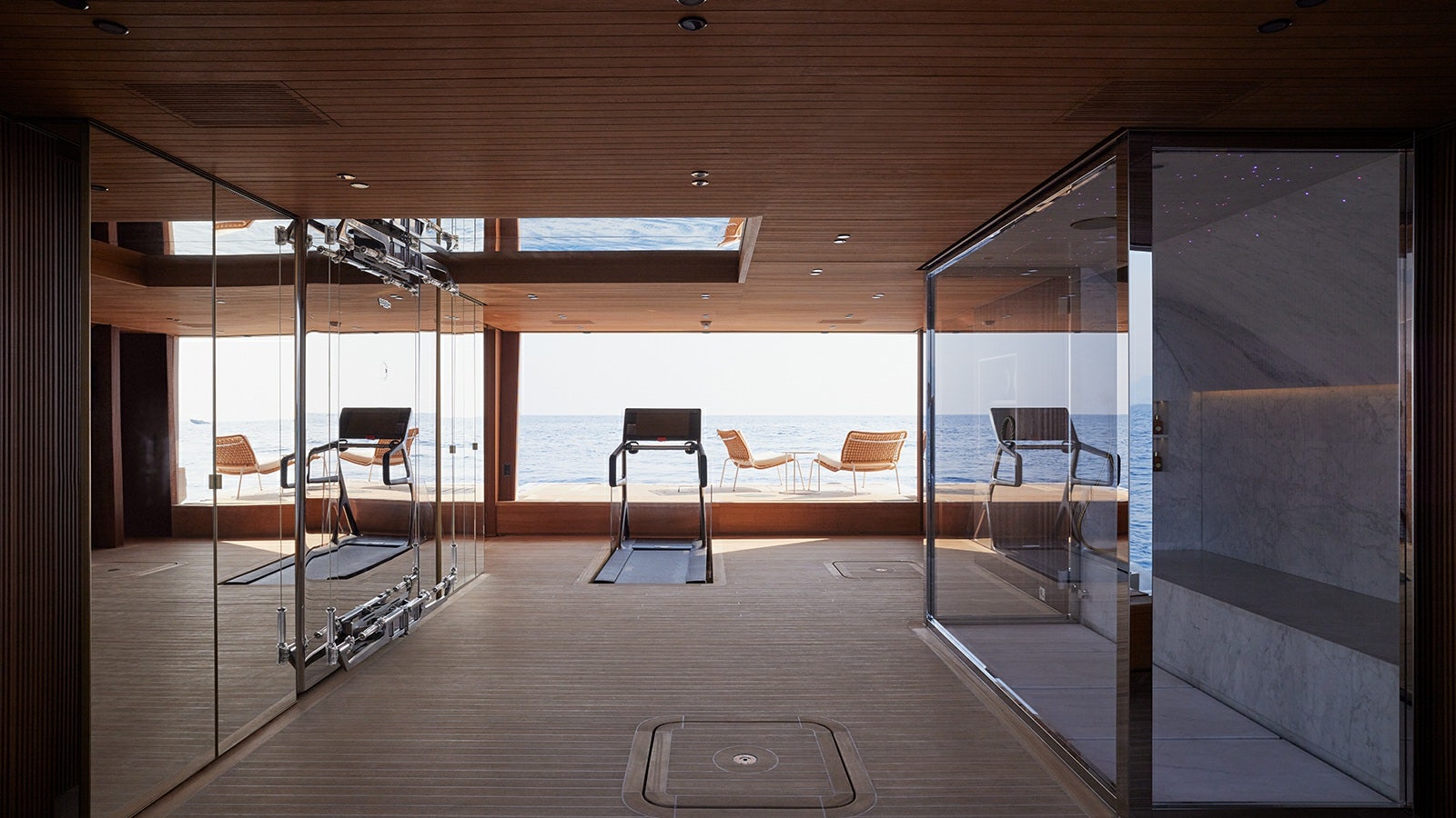 a room with a deck and chairs aboard LA LA LAND Yacht for Charter