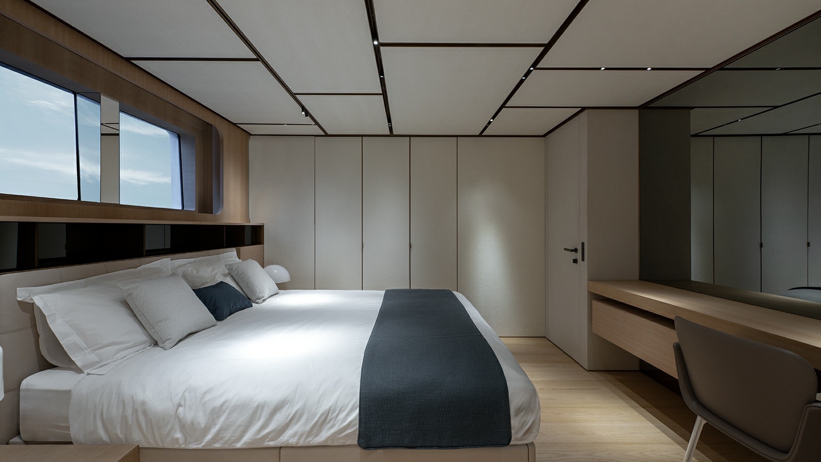 a room with a bed and a desk aboard LA LA LAND Yacht for Charter