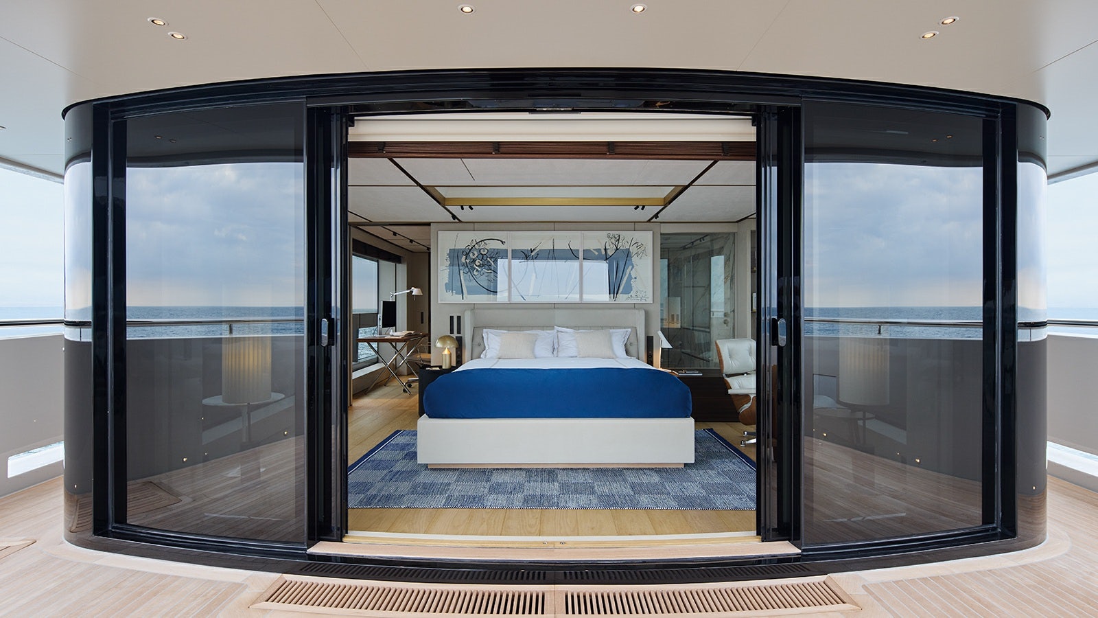 a room with a bed and a sliding glass door aboard LA LA LAND Yacht for Charter