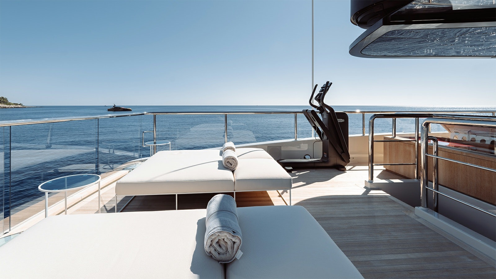 a deck with a large pool and a large boat on it aboard LA LA LAND Yacht for Charter