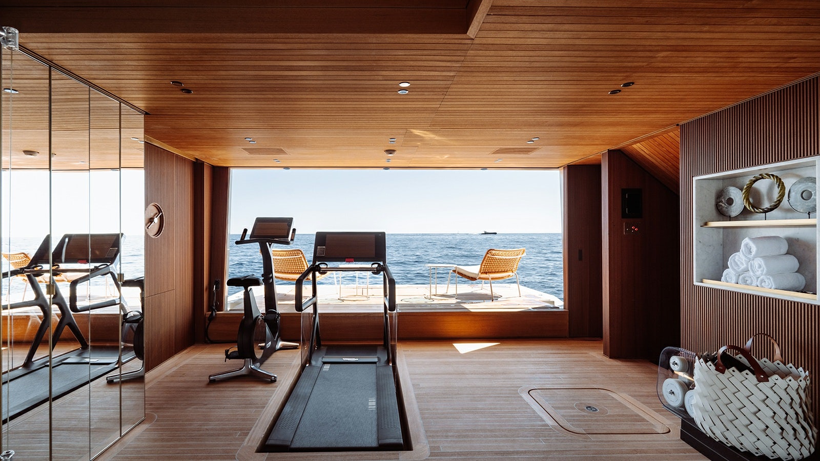 a room with a table chairs and a bench aboard LA LA LAND Yacht for Charter