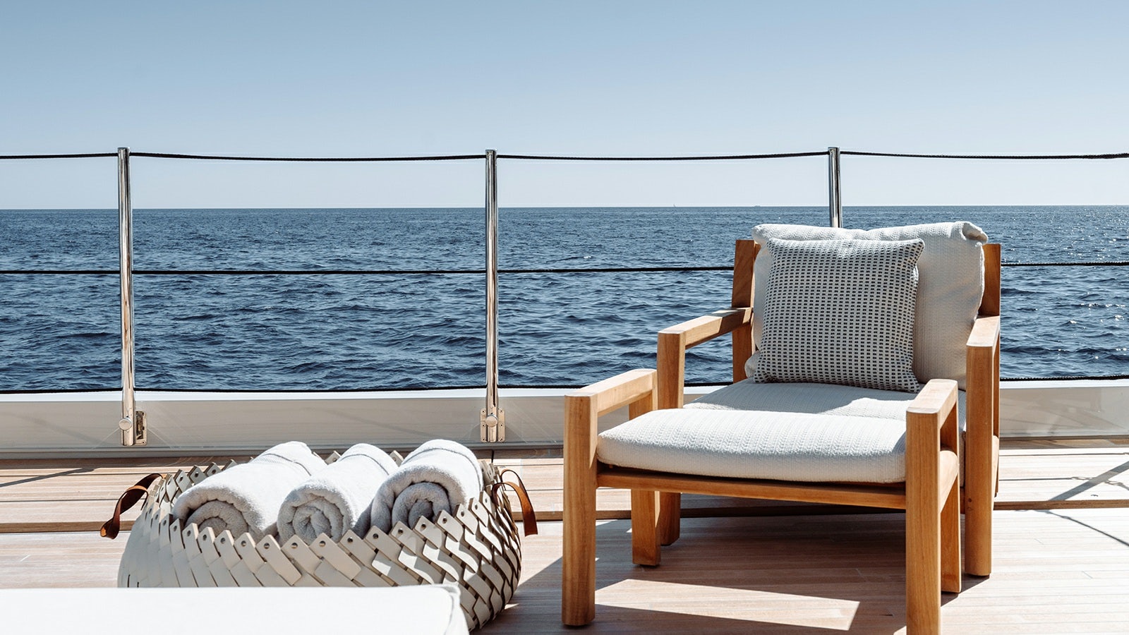 two chairs on a deck overlooking the ocean aboard LA LA LAND Yacht for Charter