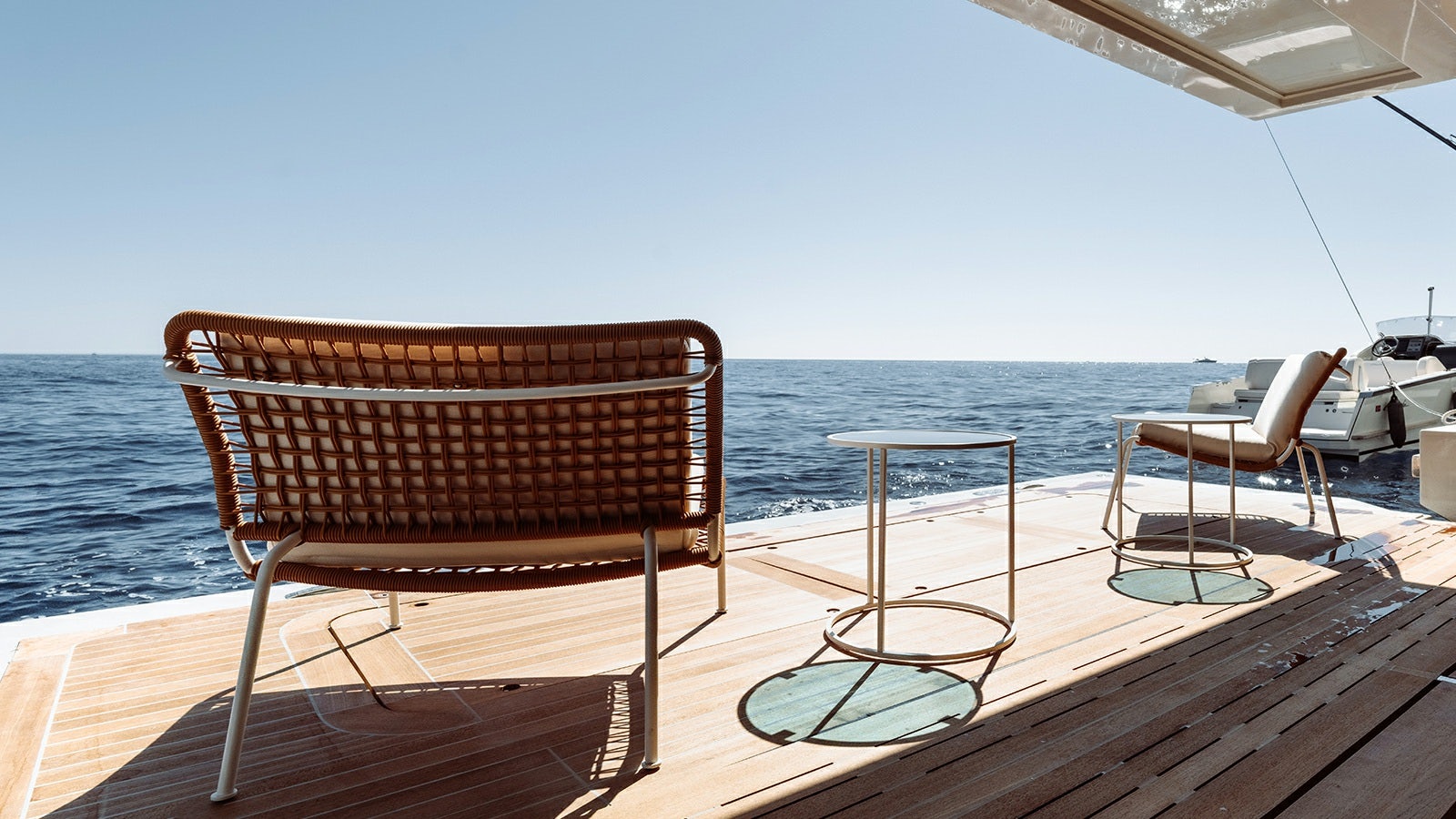 a couple of chairs on a deck overlooking a body of water aboard LA LA LAND Yacht for Charter