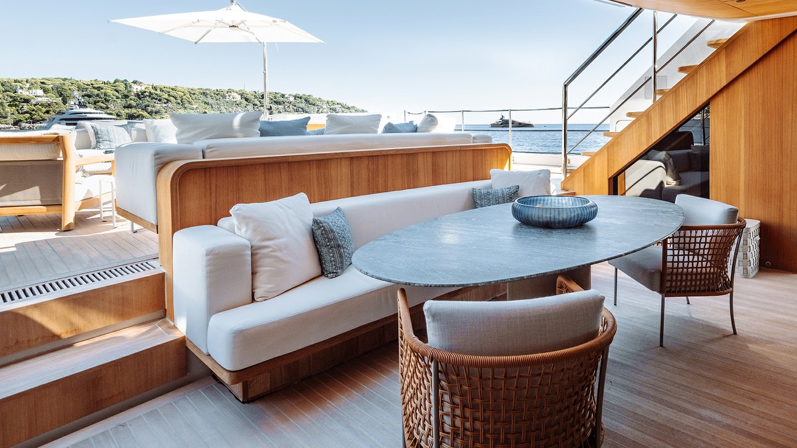 a table and chairs on a deck aboard LA LA LAND Yacht for Charter
