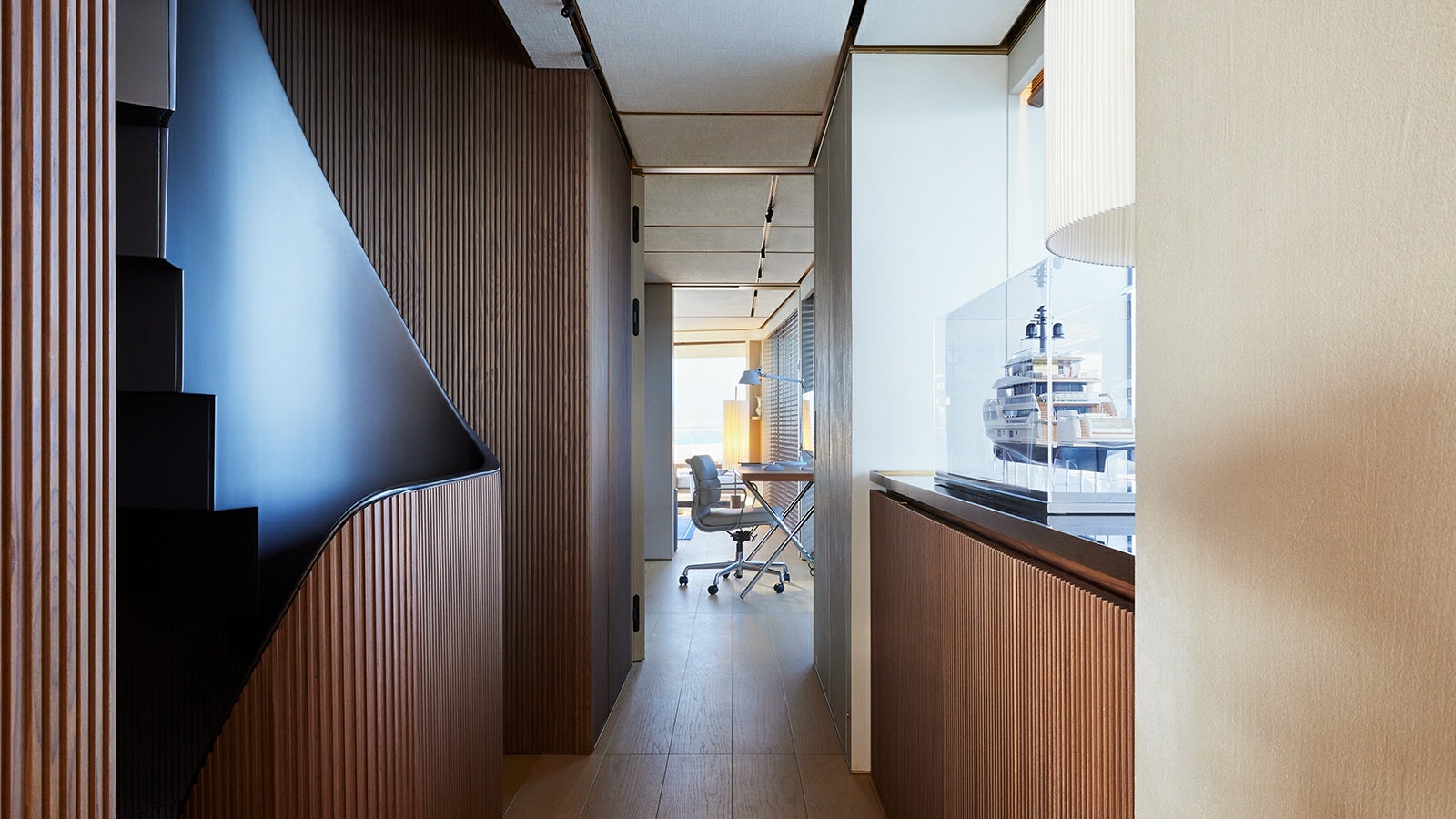 a hallway with a desk and chairs aboard LA LA LAND Yacht for Charter
