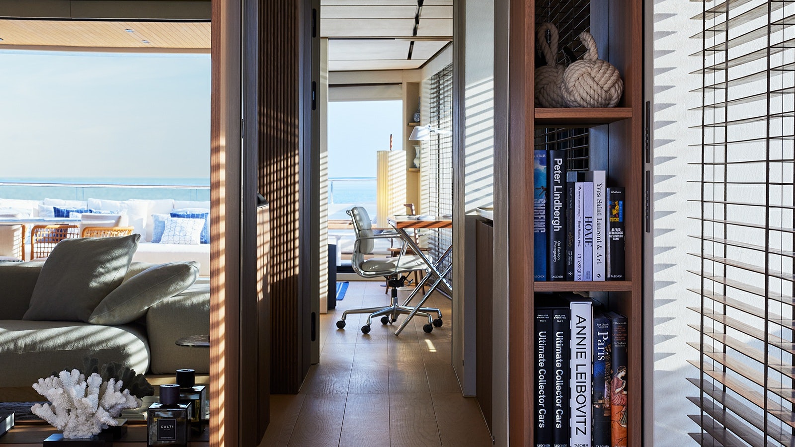 a room with a couch and a table and a chair aboard LA LA LAND Yacht for Charter