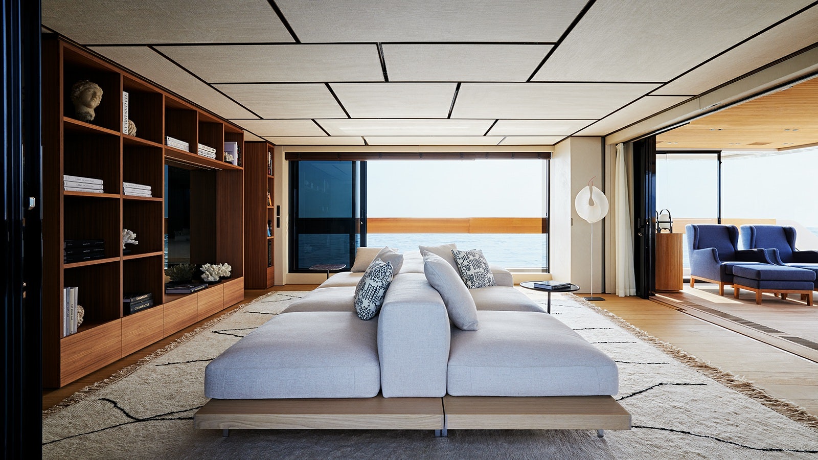 a living room with a couch and a large window aboard LA LA LAND Yacht for Charter