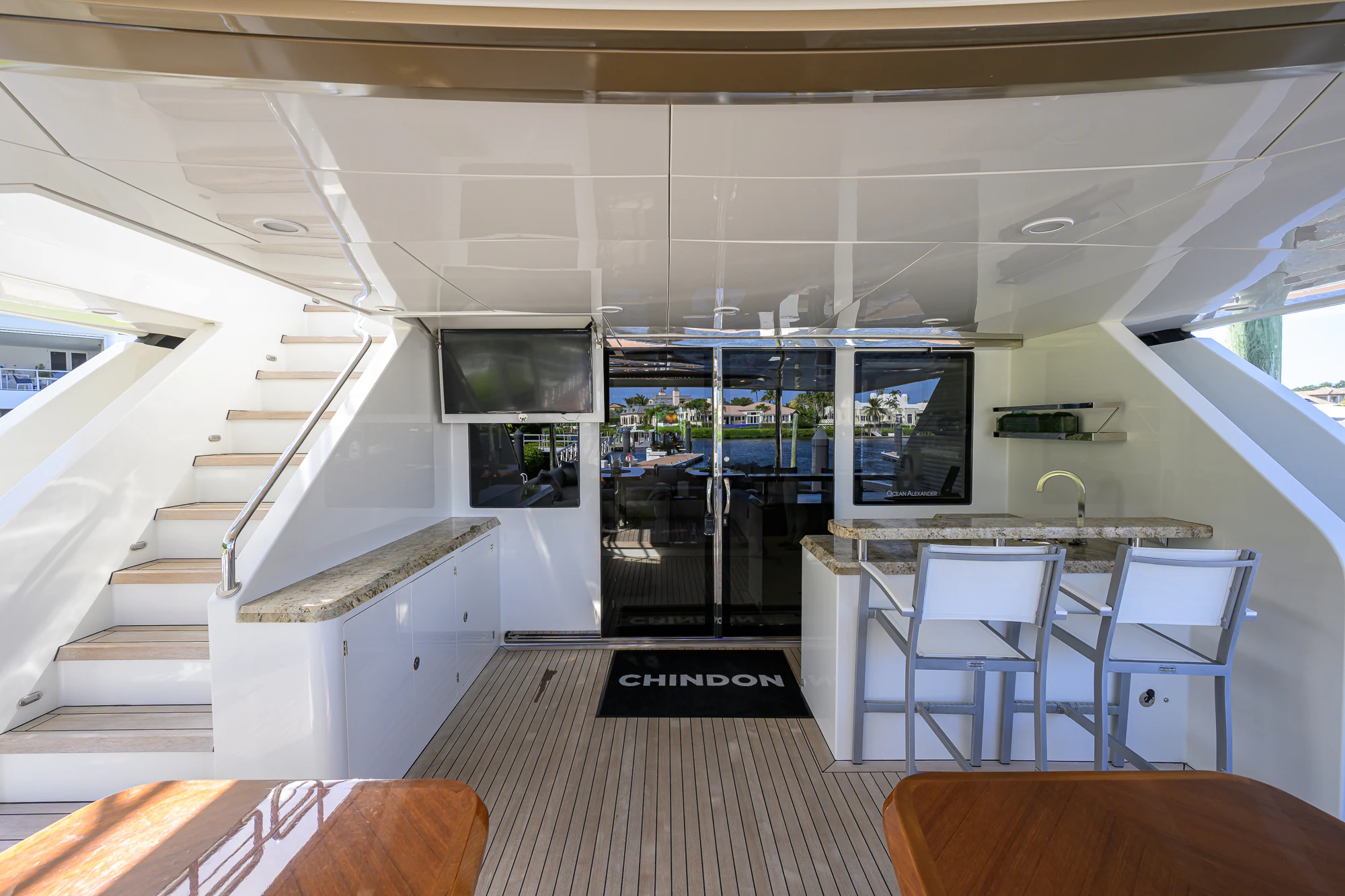 inside of a building with a staircase and chairs aboard CHINDON Yacht for Sale