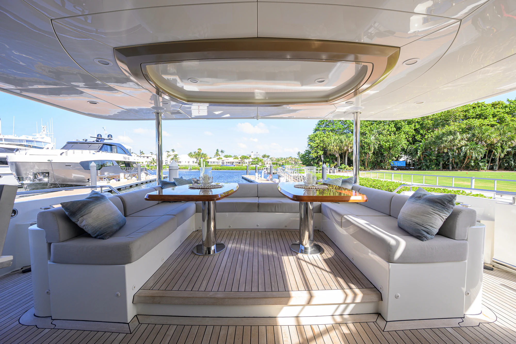 a large white lounge chair next to a table and a large white sofa aboard CHINDON Yacht for Sale
