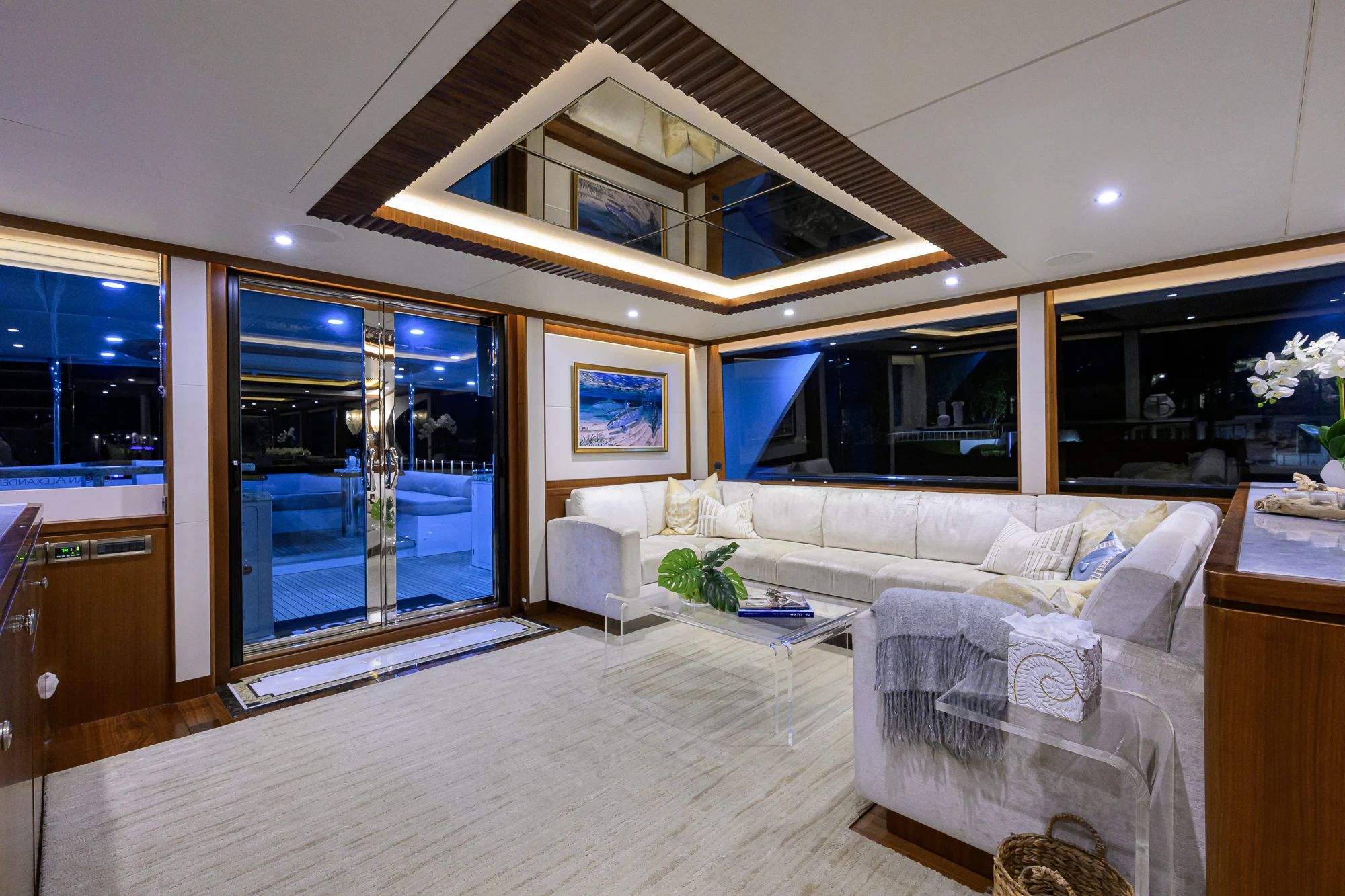 a living room with a large chandelier aboard CHINDON Yacht for Sale