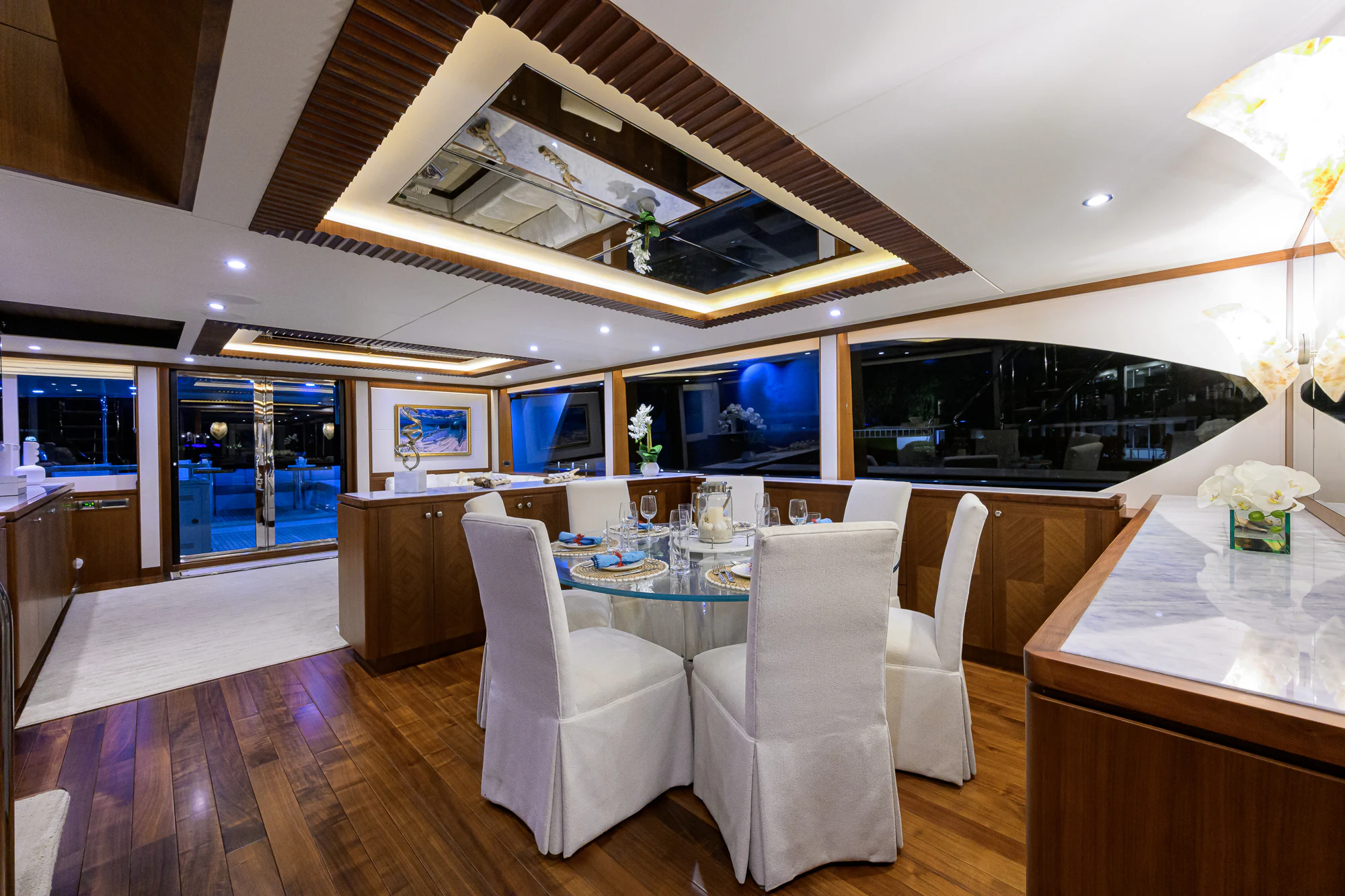 a room with a table chairs and a large window aboard CHINDON Yacht for Sale