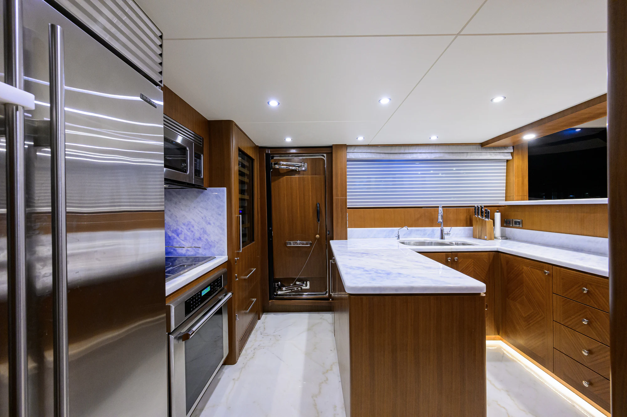 a kitchen with a large refrigerator aboard CHINDON Yacht for Sale