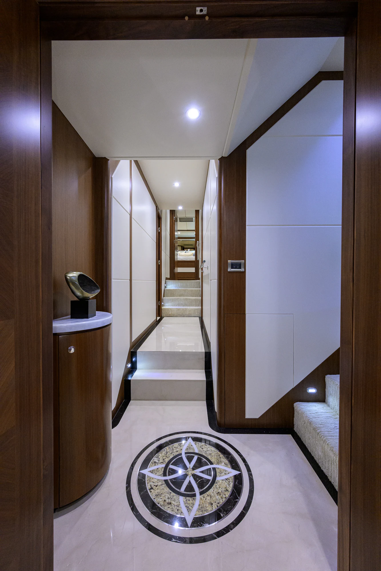a hallway with a round mirror aboard CHINDON Yacht for Sale