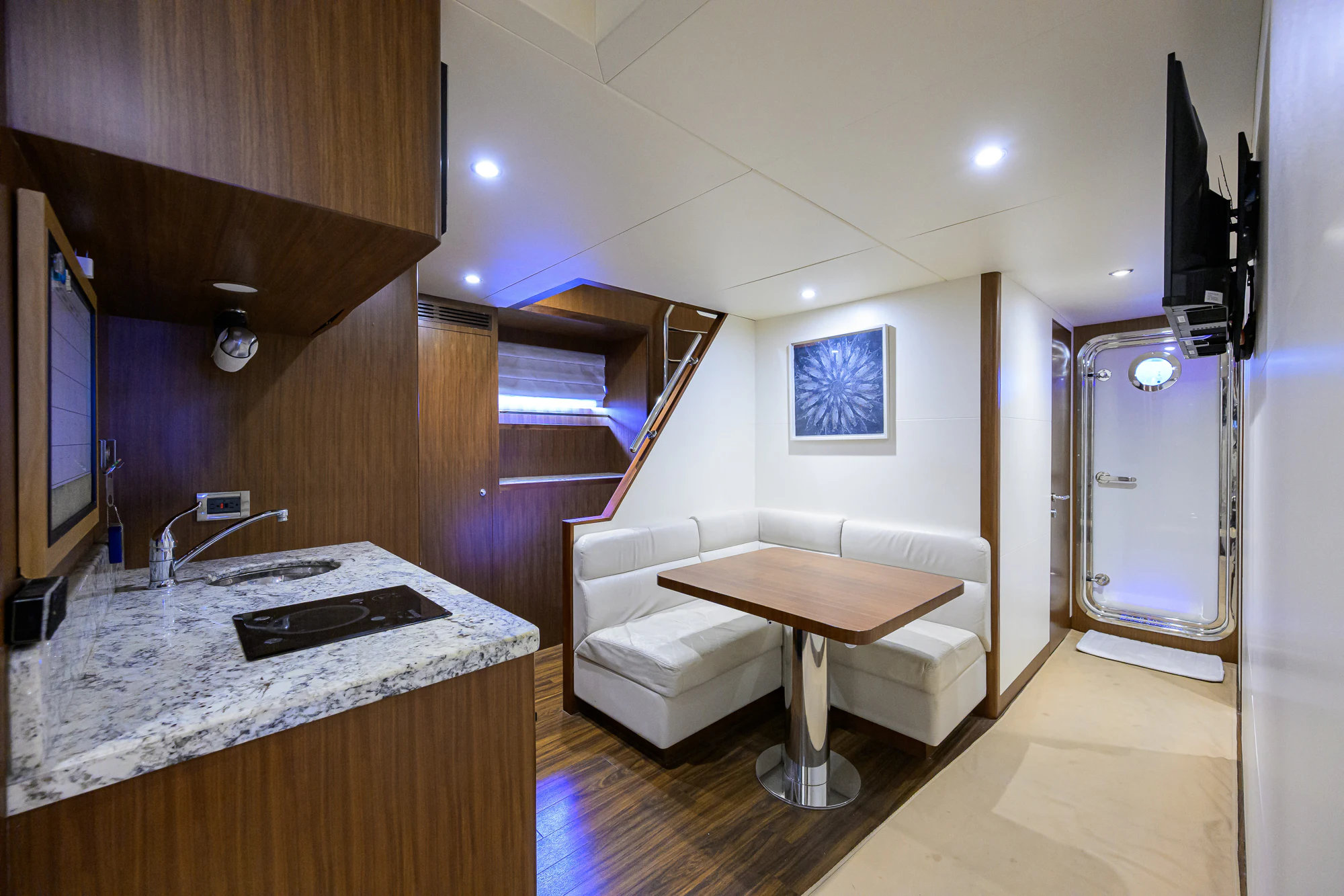 a kitchen with a table and a bench aboard CHINDON Yacht for Sale