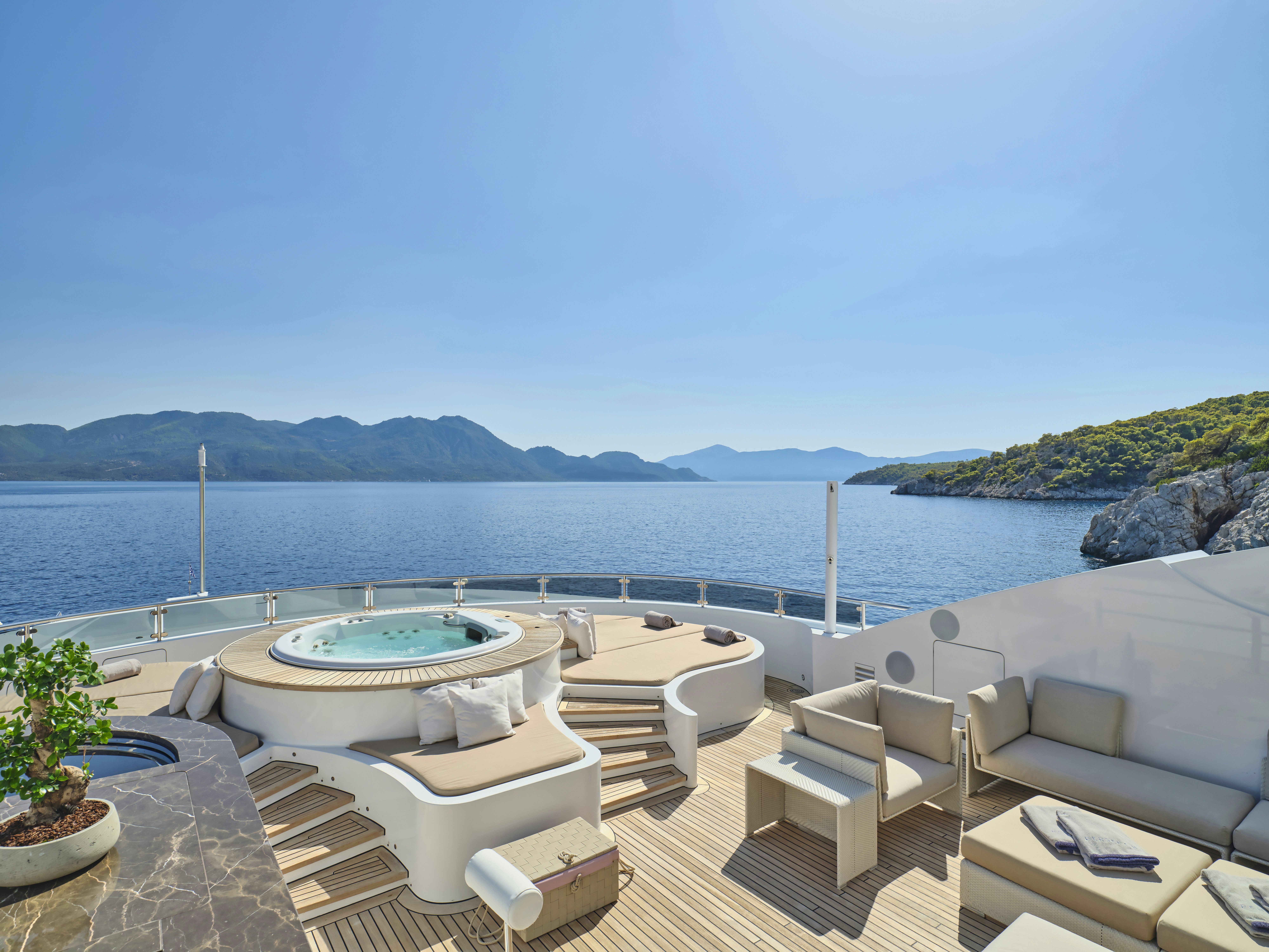 a pool with a deck and chairs aboard PERSEFONI I Yacht for Charter