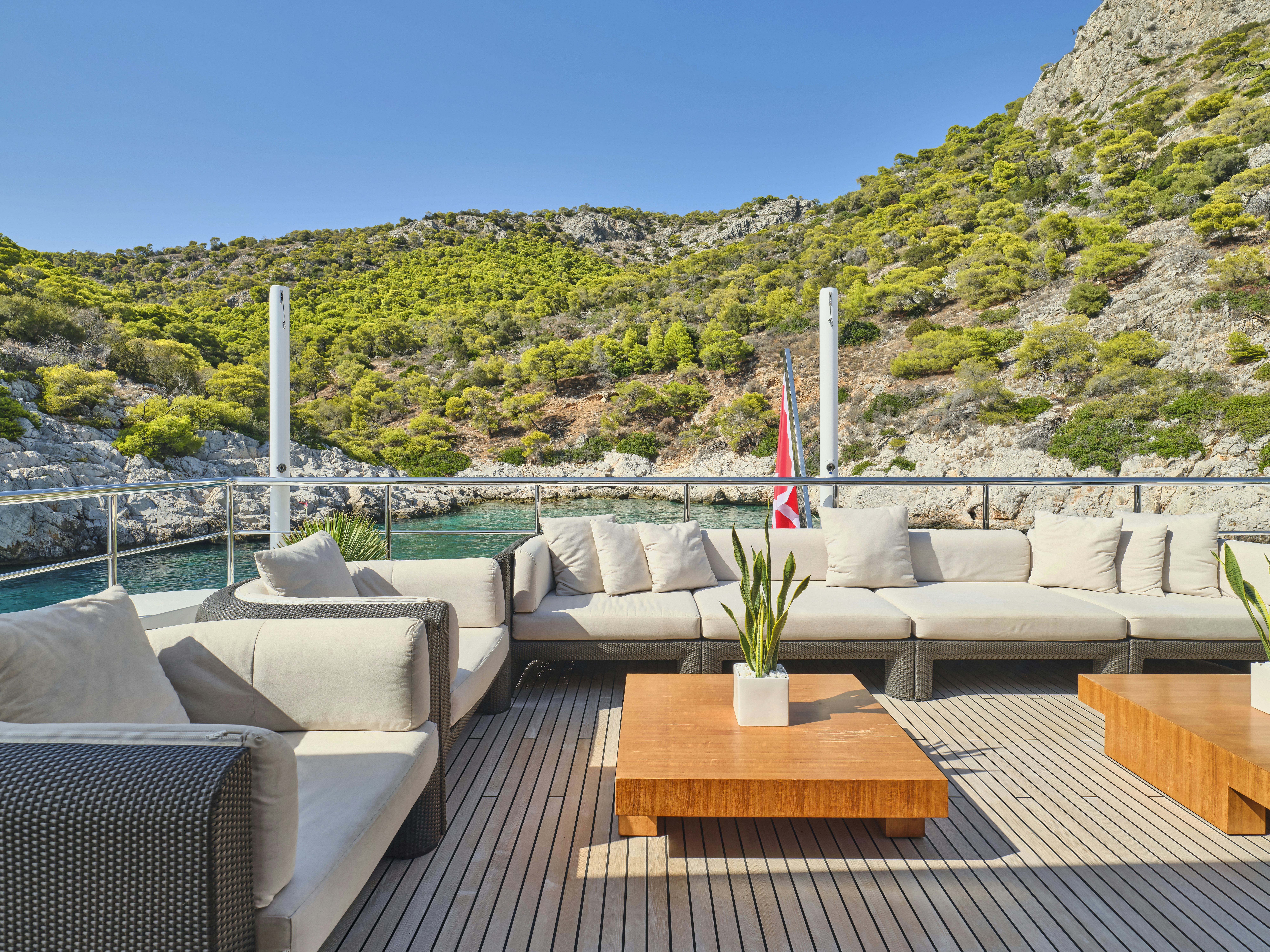 a deck with chairs and a table on it aboard PERSEFONI I Yacht for Charter
