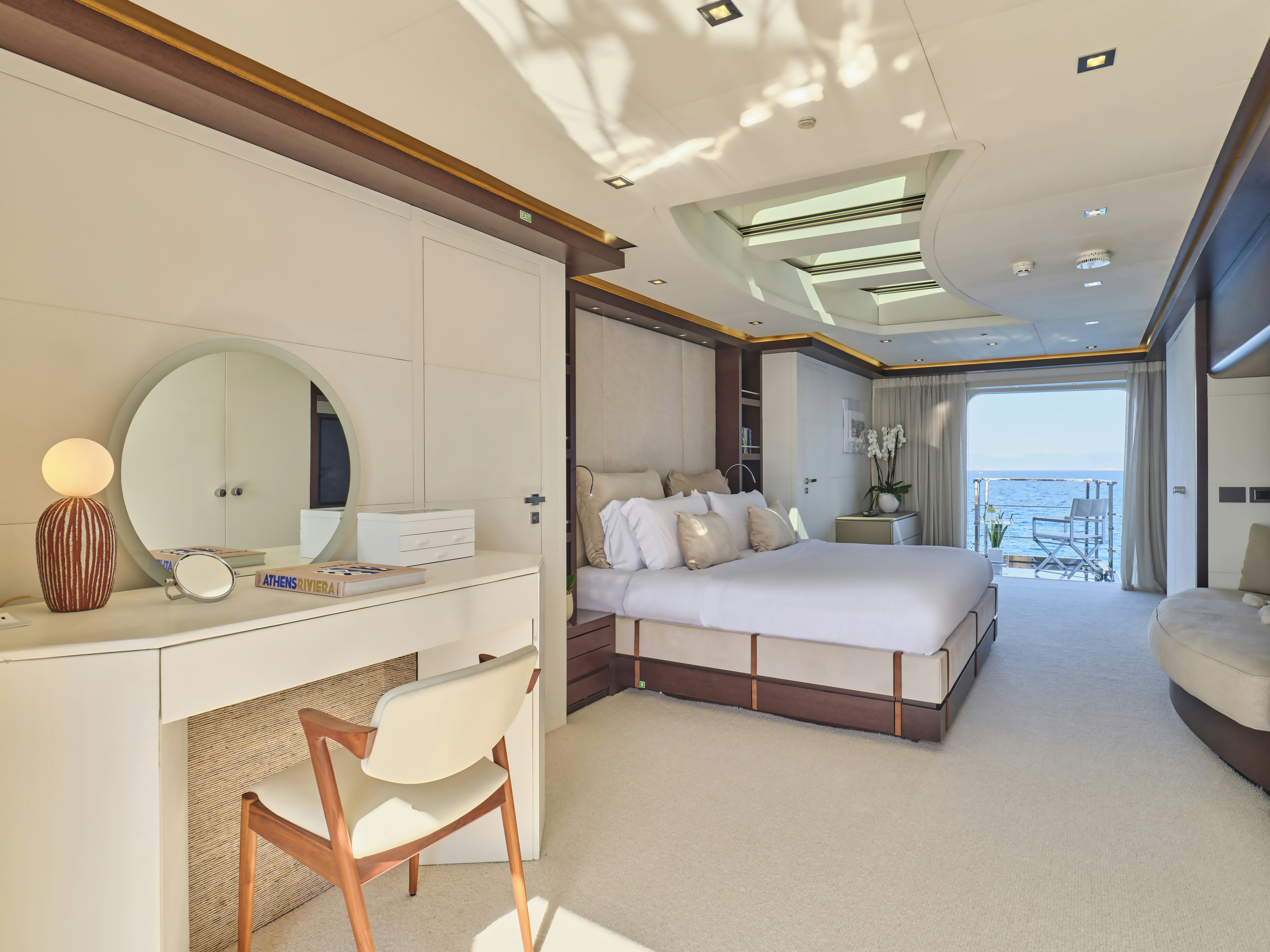 a bedroom with a bed and a desk aboard PERSEFONI I Yacht for Charter