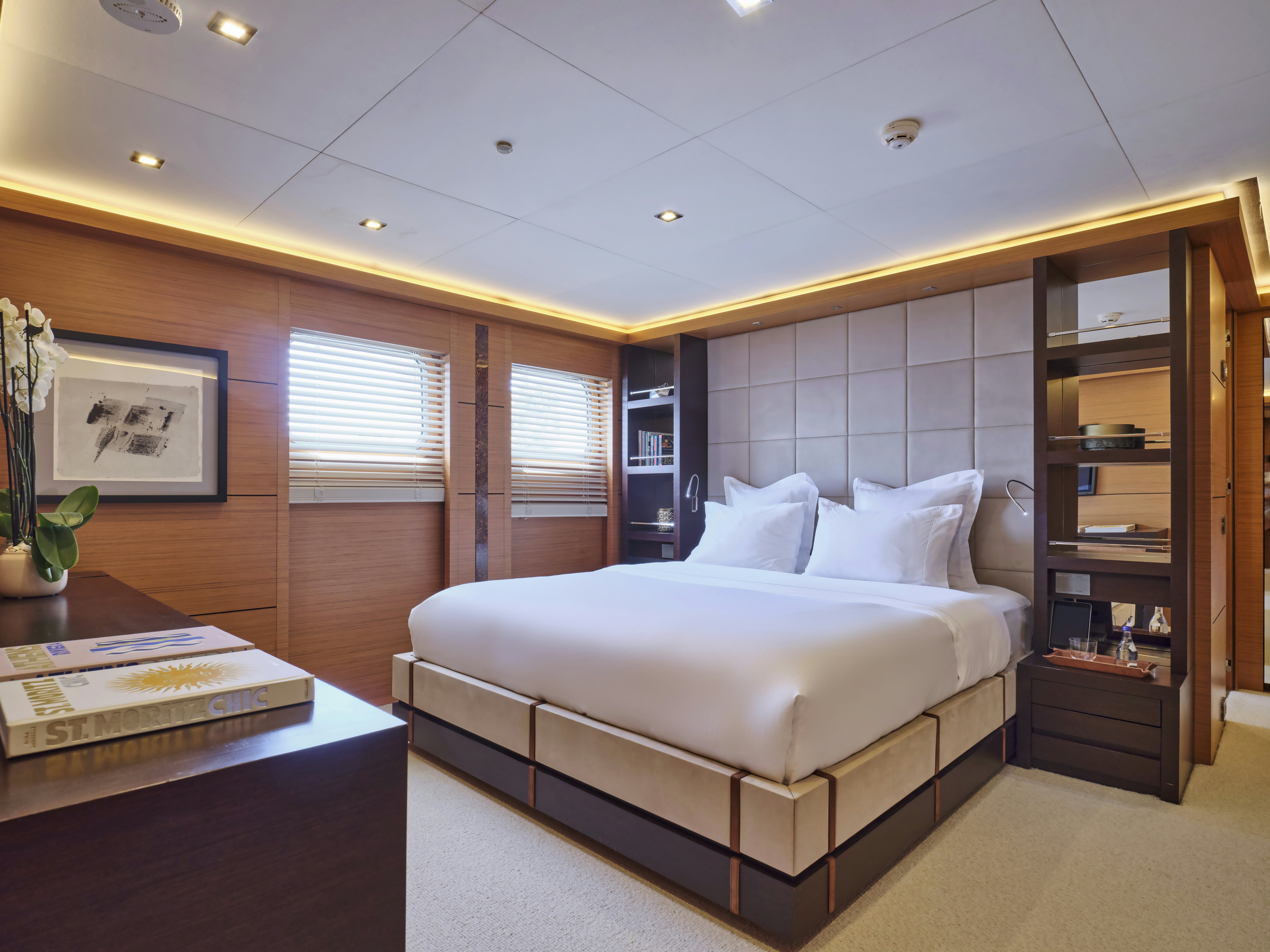 a bedroom with a bed and a bookcase aboard PERSEFONI I Yacht for Charter