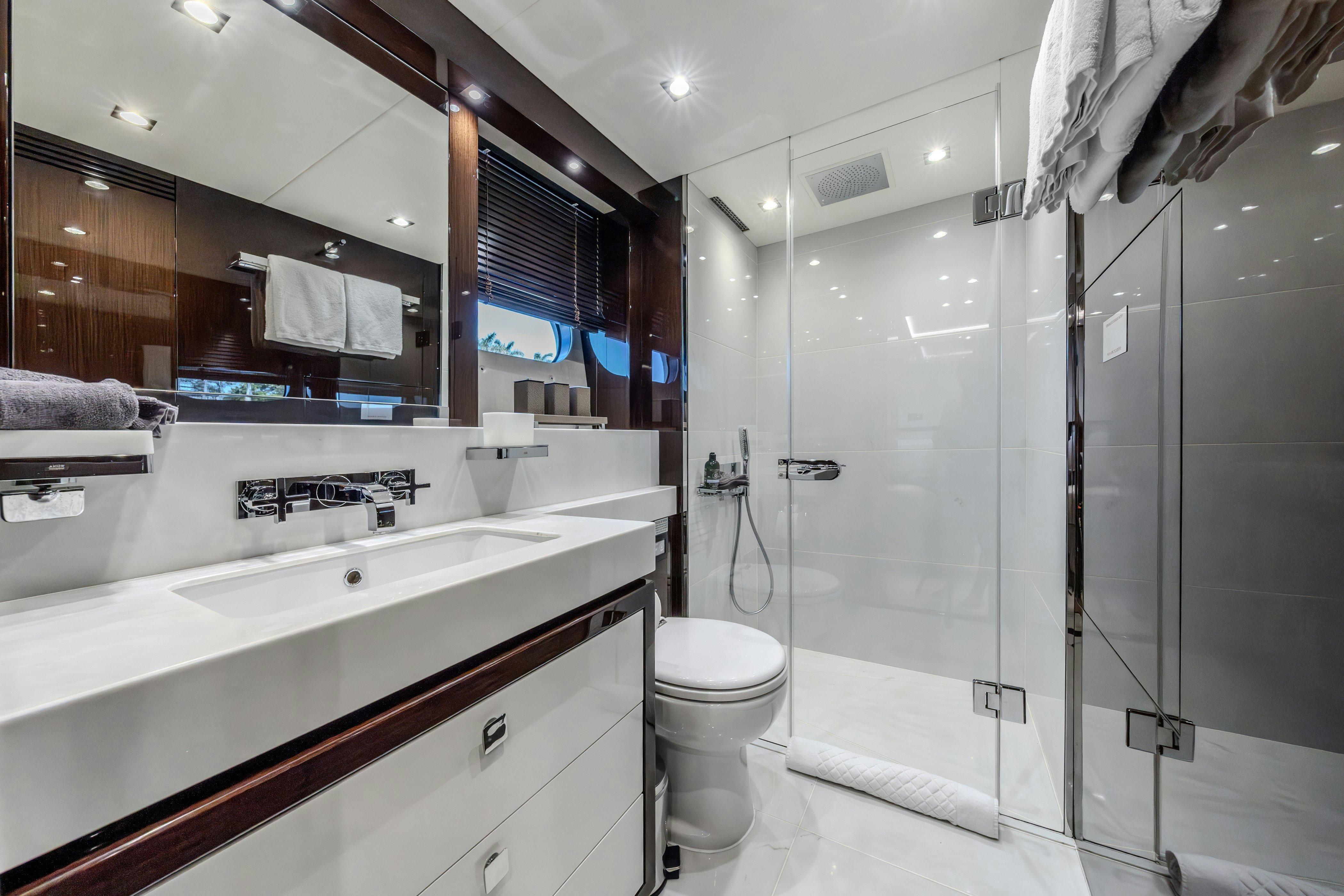 a bathroom with a glass shower aboard LOST BOYS Yacht for Sale