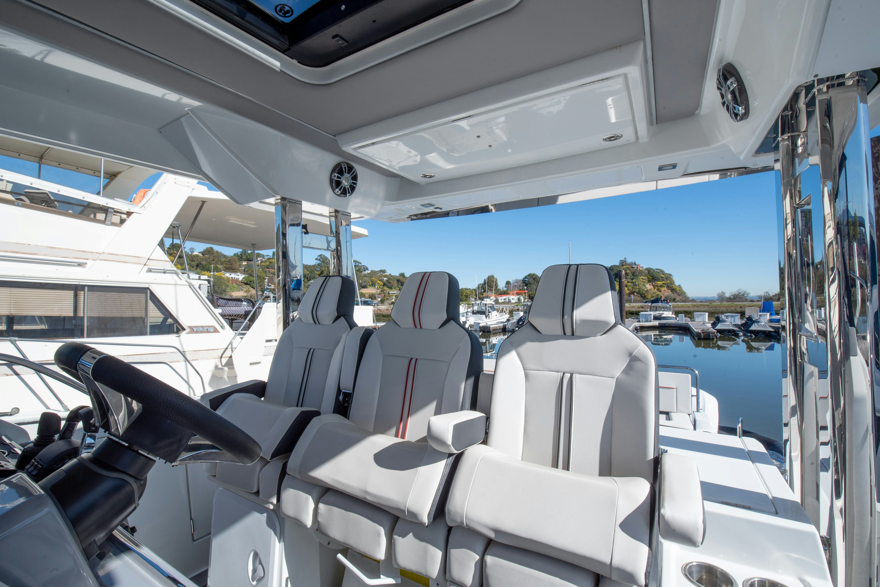 inside of a vehicle with chairs and tables and a body of water aboard NAUTI BRIGI GULL Yacht for Sale