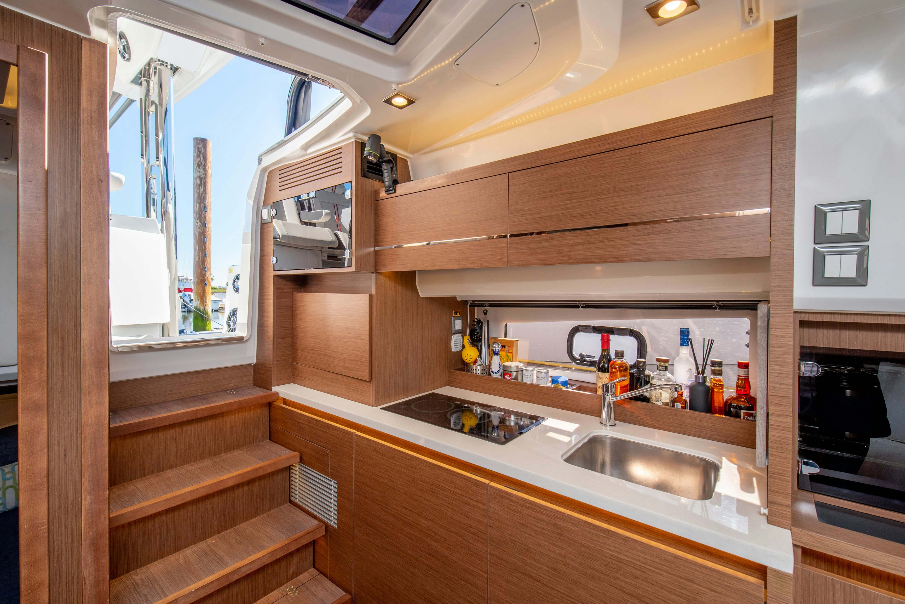 a kitchen with wooden cabinets aboard NAUTI BRIGI GULL Yacht for Sale