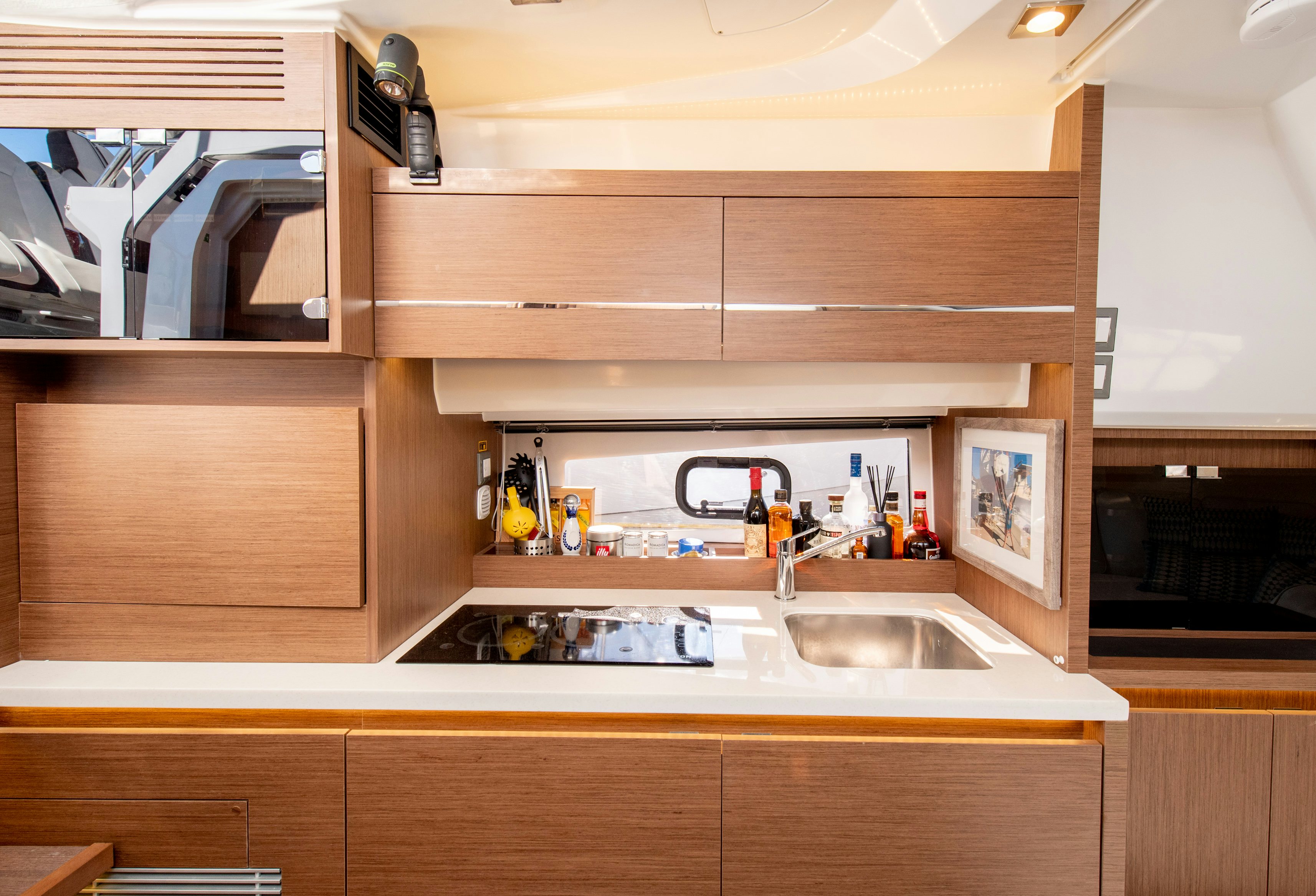 a kitchen with wooden cabinets aboard NAUTI BRIGI GULL Yacht for Sale
