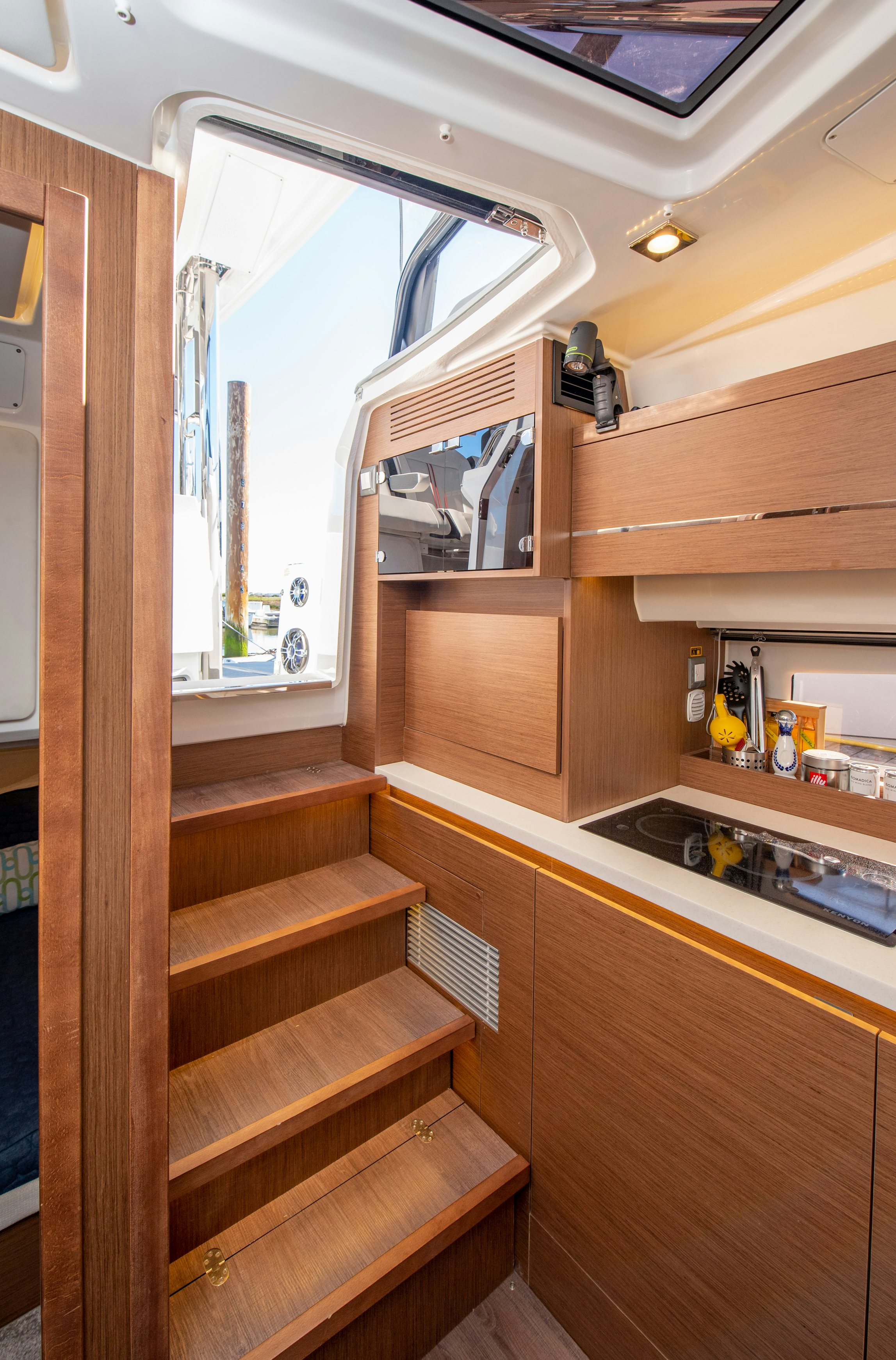 a kitchen with wooden cabinets aboard NAUTI BRIGI GULL Yacht for Sale