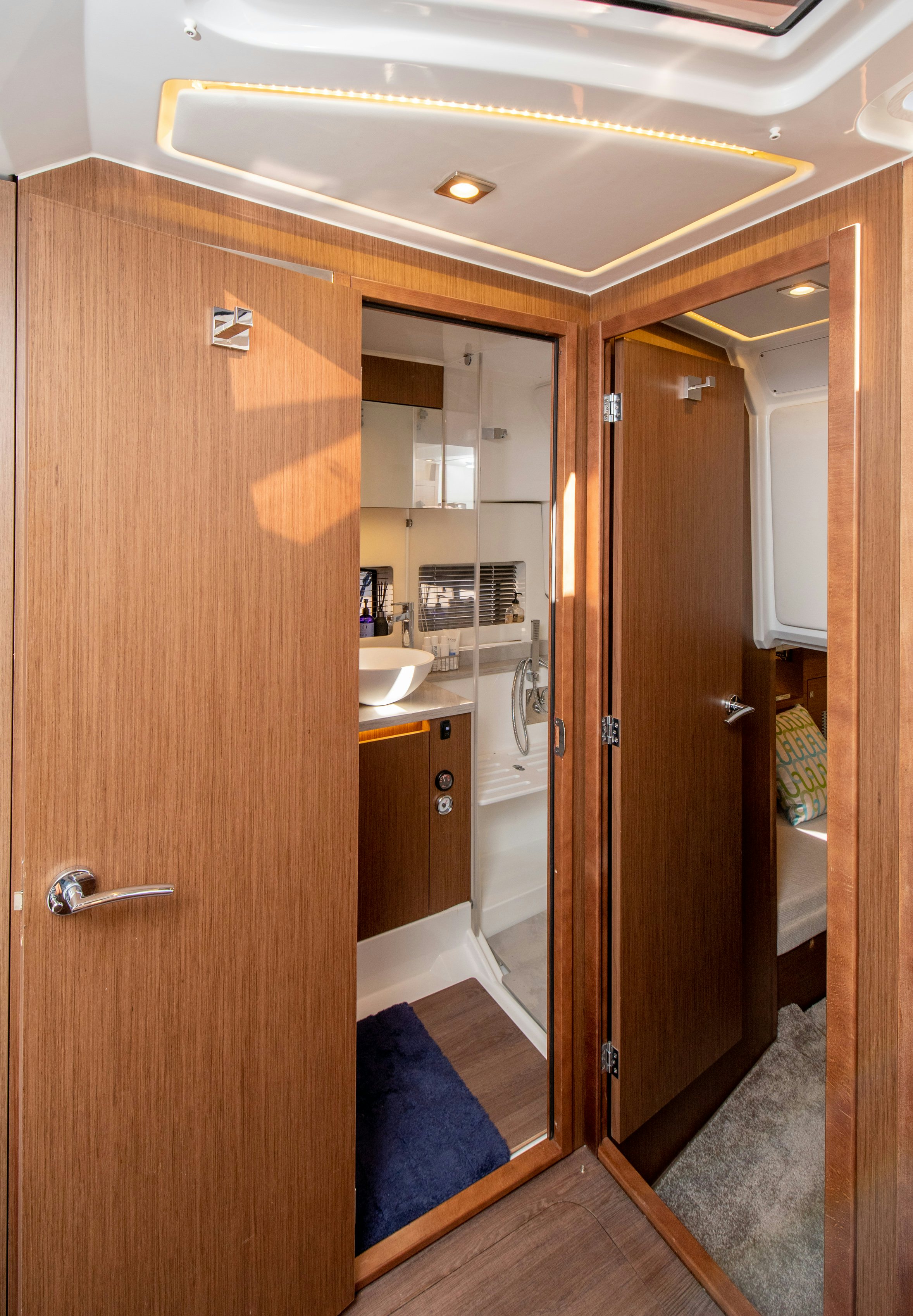 a bathroom with a wood door aboard NAUTI BRIGI GULL Yacht for Sale