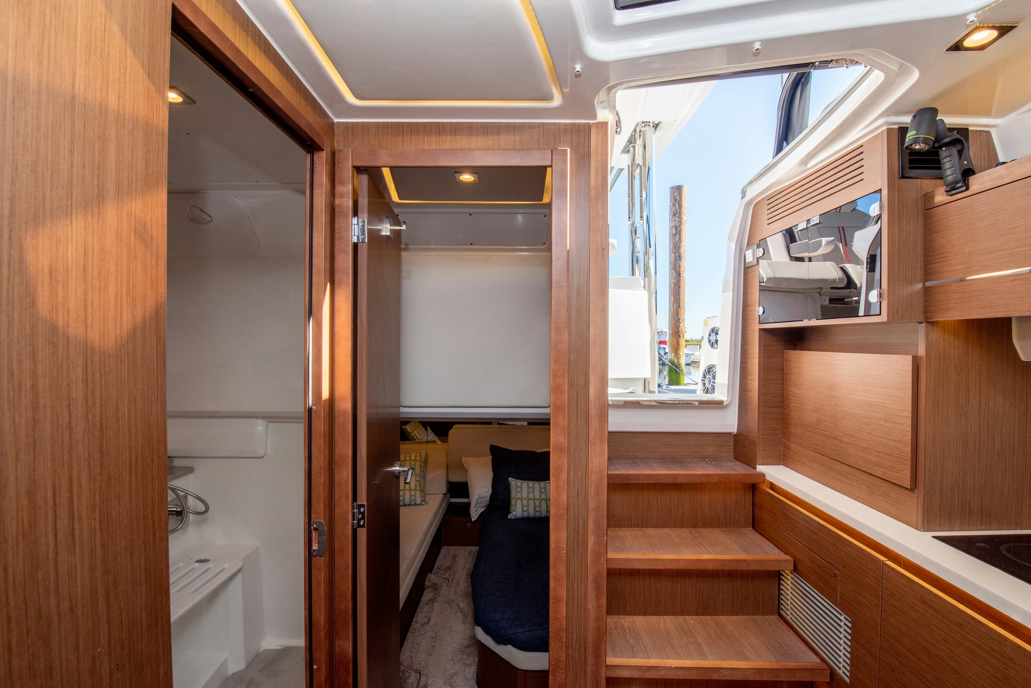 a room with a bed and a mirror aboard NAUTI BRIGI GULL Yacht for Sale
