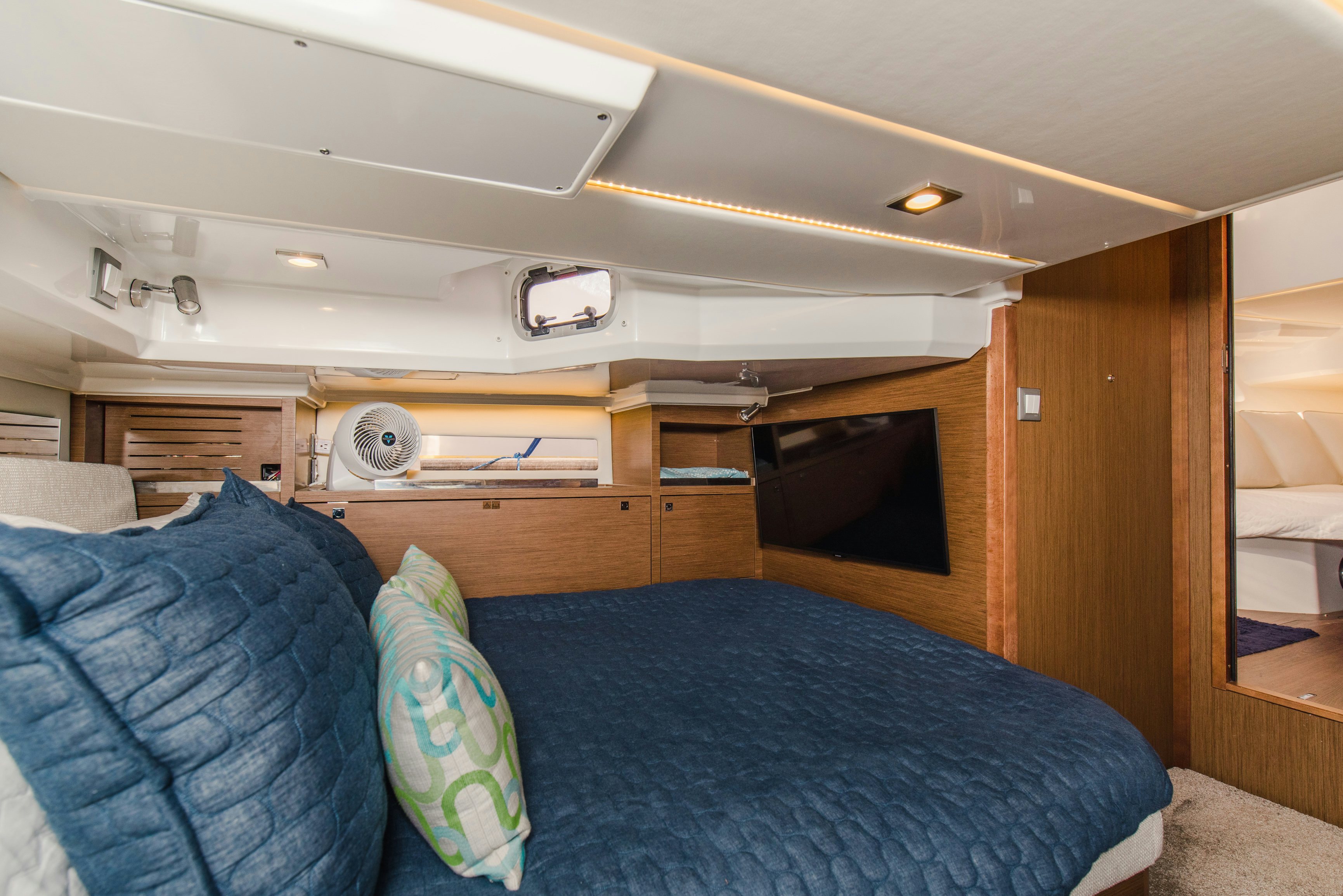 a bedroom with a bed and a fan aboard NAUTI BRIGI GULL Yacht for Sale