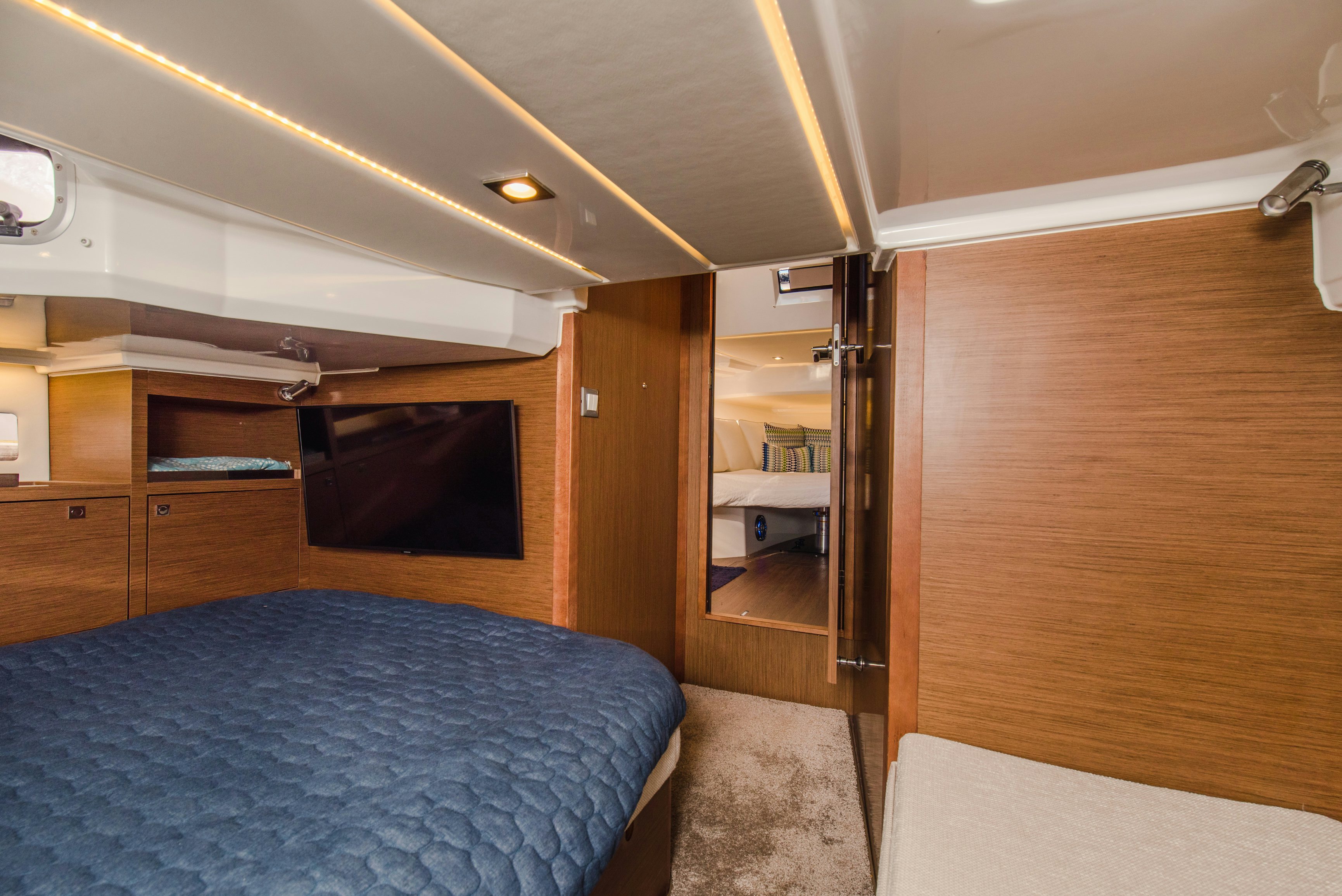 a bedroom with a bed and a tv aboard NAUTI BRIGI GULL Yacht for Sale